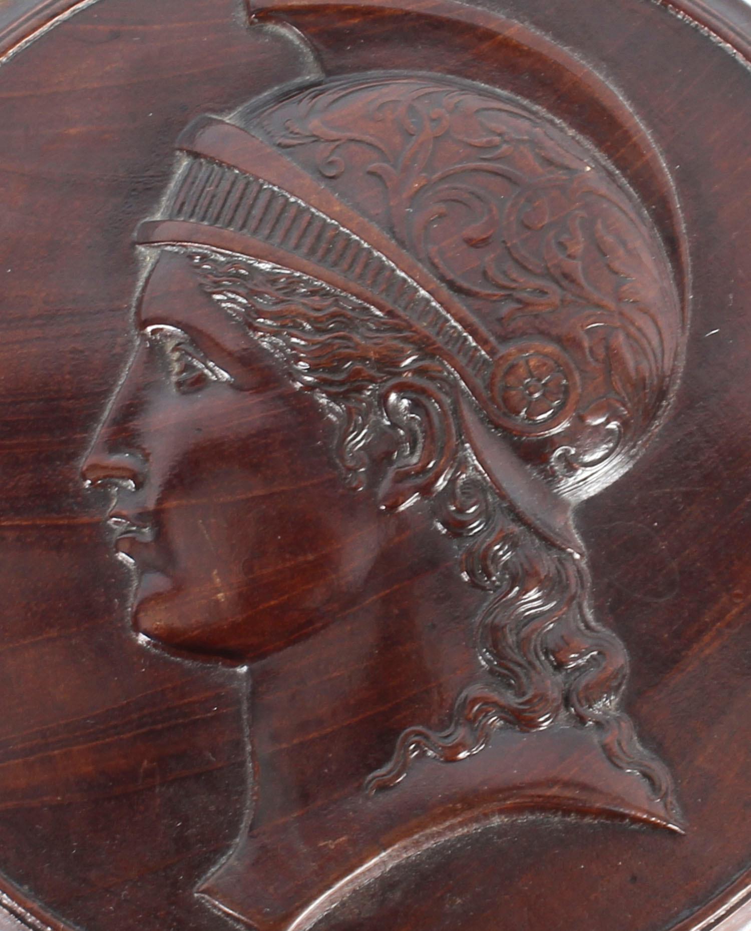 This beautiful Italian Grand Tour mahogany roundel plaque profile bust depicting Minerva dating from the mid-19th century.
 
The sensitively carved plaque depicts the profile of Minerva, the Roman goddess of wisdom and strategic warfare, in high
