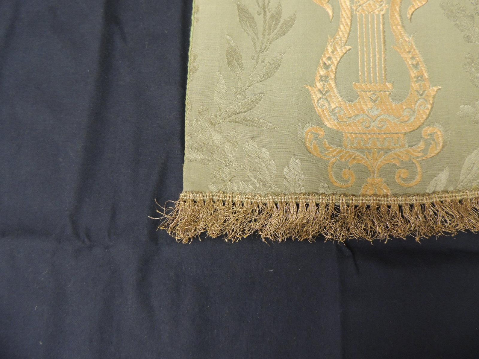 Antique Italian green and gold silk brocade textile.
Depicting vines and harps with small fringe trim at the bottom and satin green backing.
Sold as is.
Ideal for the back of a chair, to frame or to make a pillow.
Size: 17
