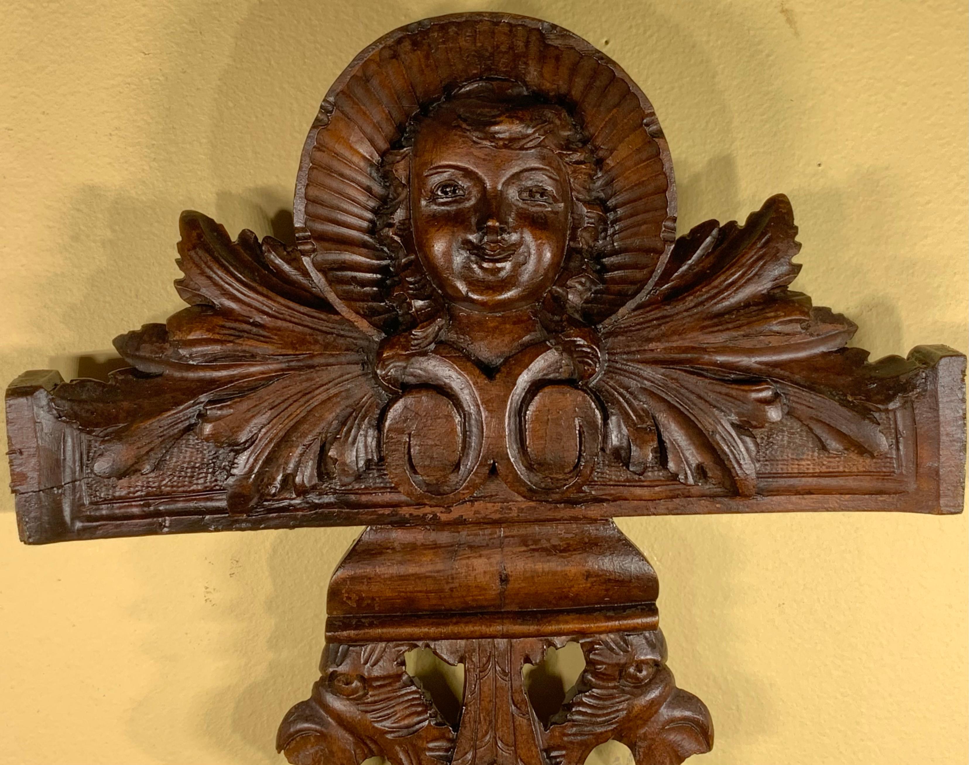 Exceptional hand carved Walnut wood, of beautiful cherub face looking forward and very intricate and intriguing bottom carving.
This 19th century decorative piece was salvege from part of antique furniture, restored and refinished to become one of