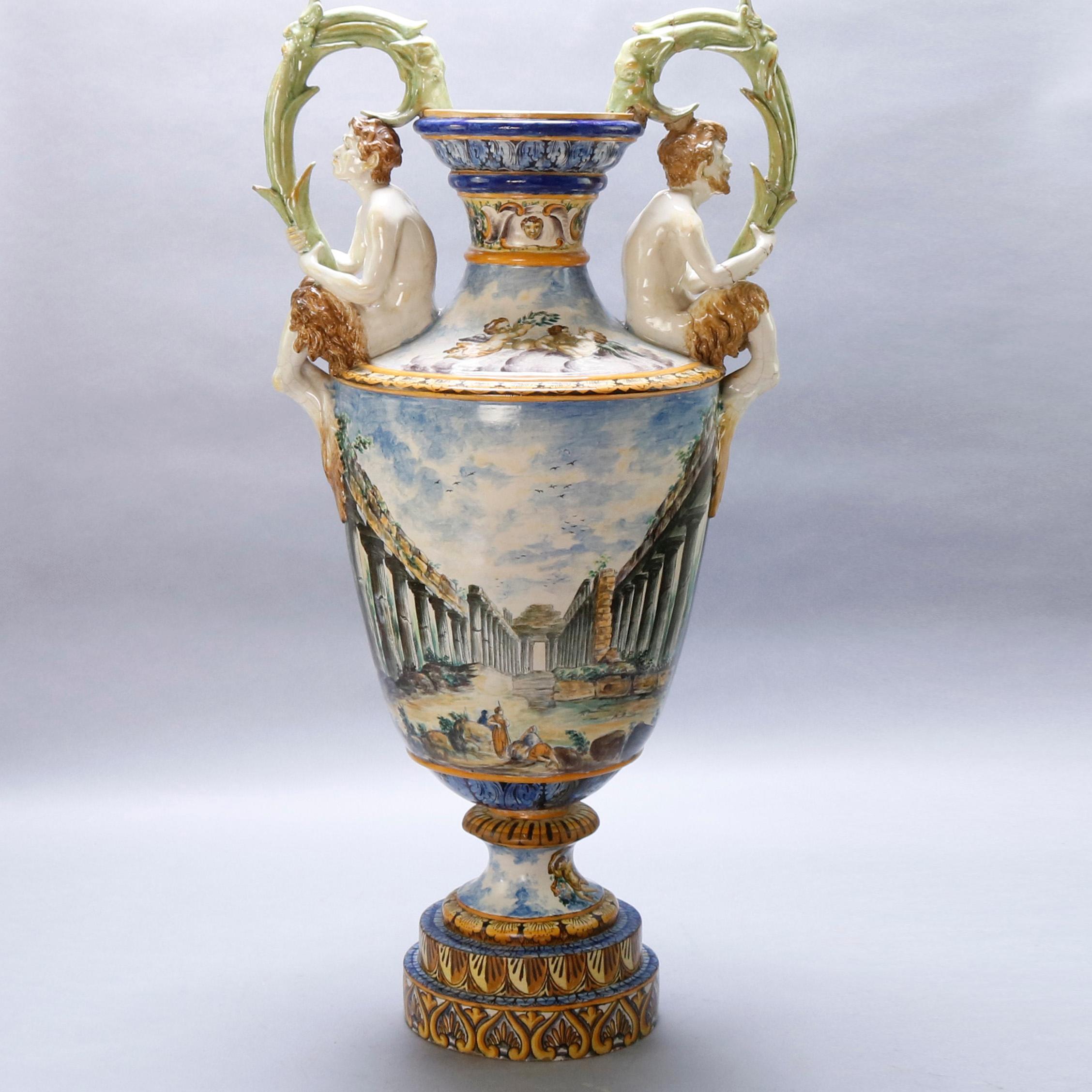 An antique Italian Majolica porcelain figural floor urn offers hand painted and gilt wraparound Classical Greek scene with figures and cherubs, flanking figural handles holding foliate elements, circa 1880

Measures: 39.5