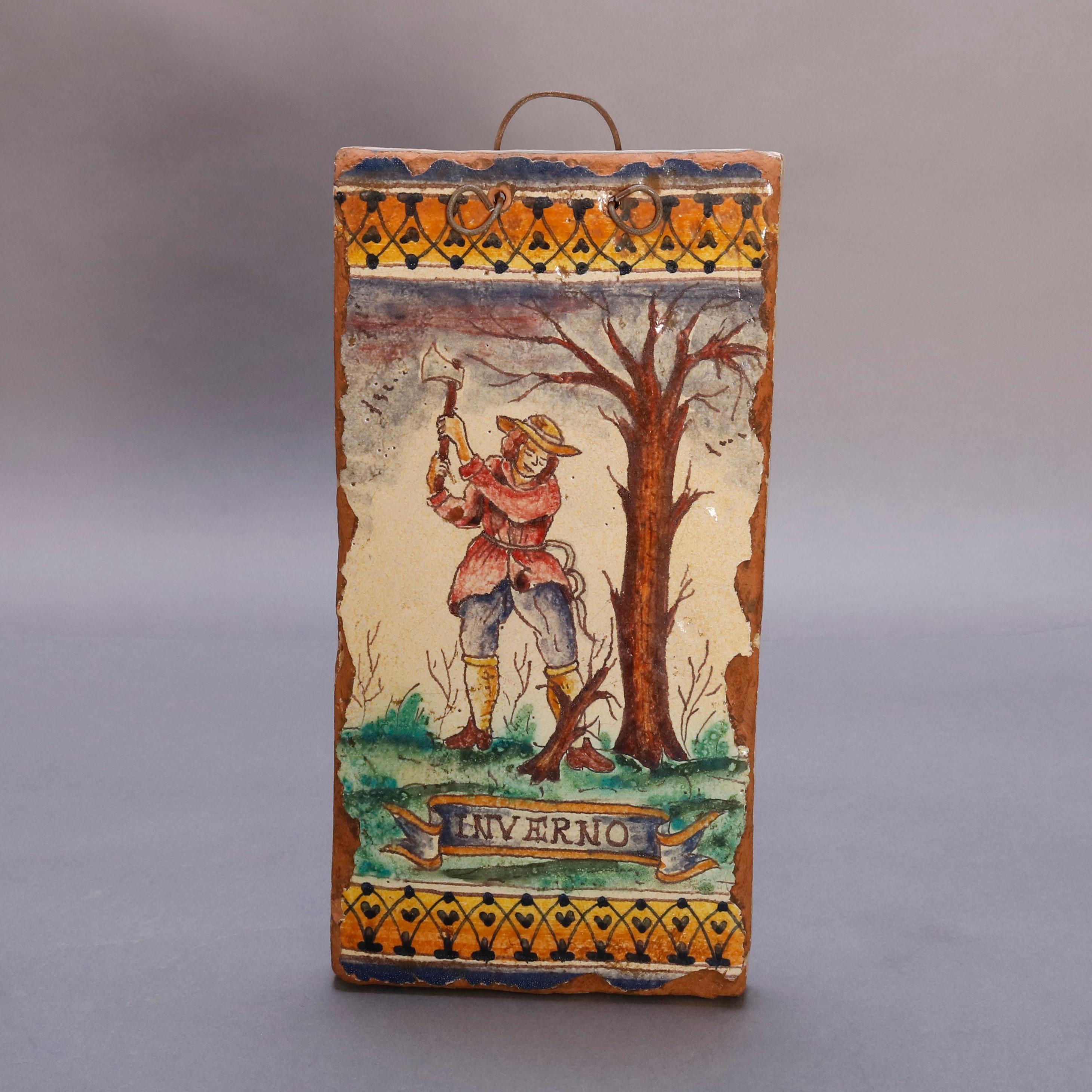 An antique set of Italian Majolica pottery tiles offer hand painted and titled scenes of the Four Seasons with figures in landscape setting; set includes 