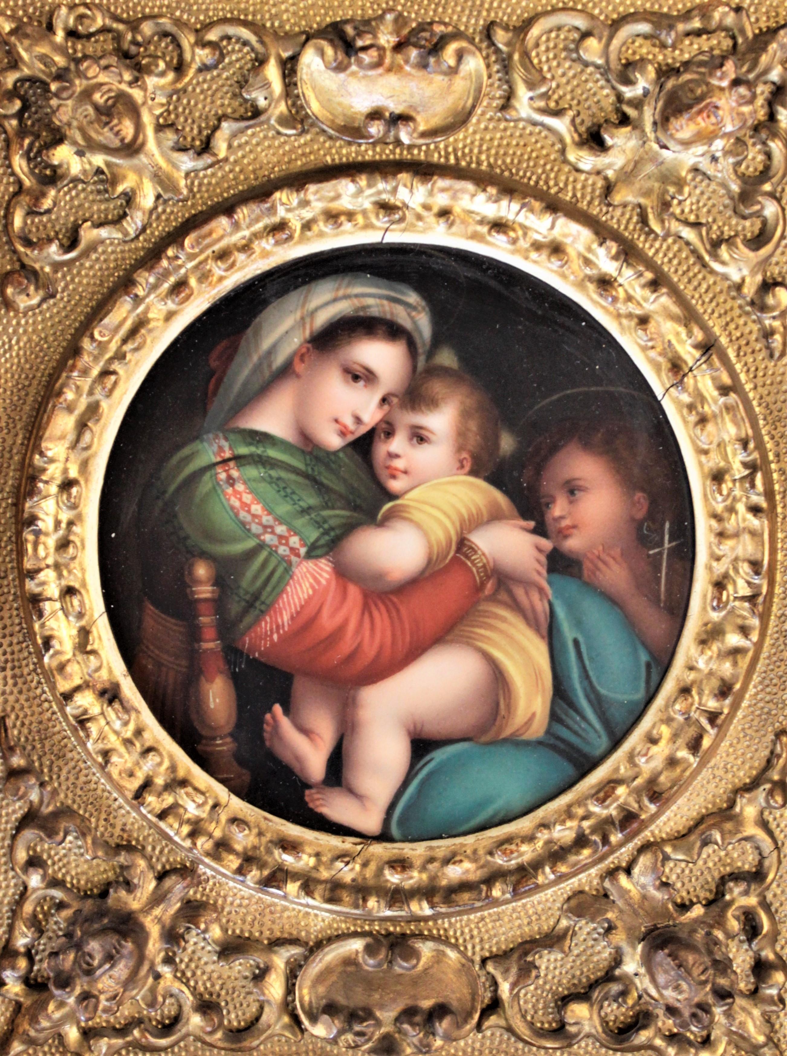 This antique hand painted porcelain panel is unsigned but was done in Italy in circa 1890 in the Roccoco style. The hand painted porcelain disc of La Madonna della Sedia, after Rafael Sanzio. The hand painted plaque depicts a seated Madonna with a