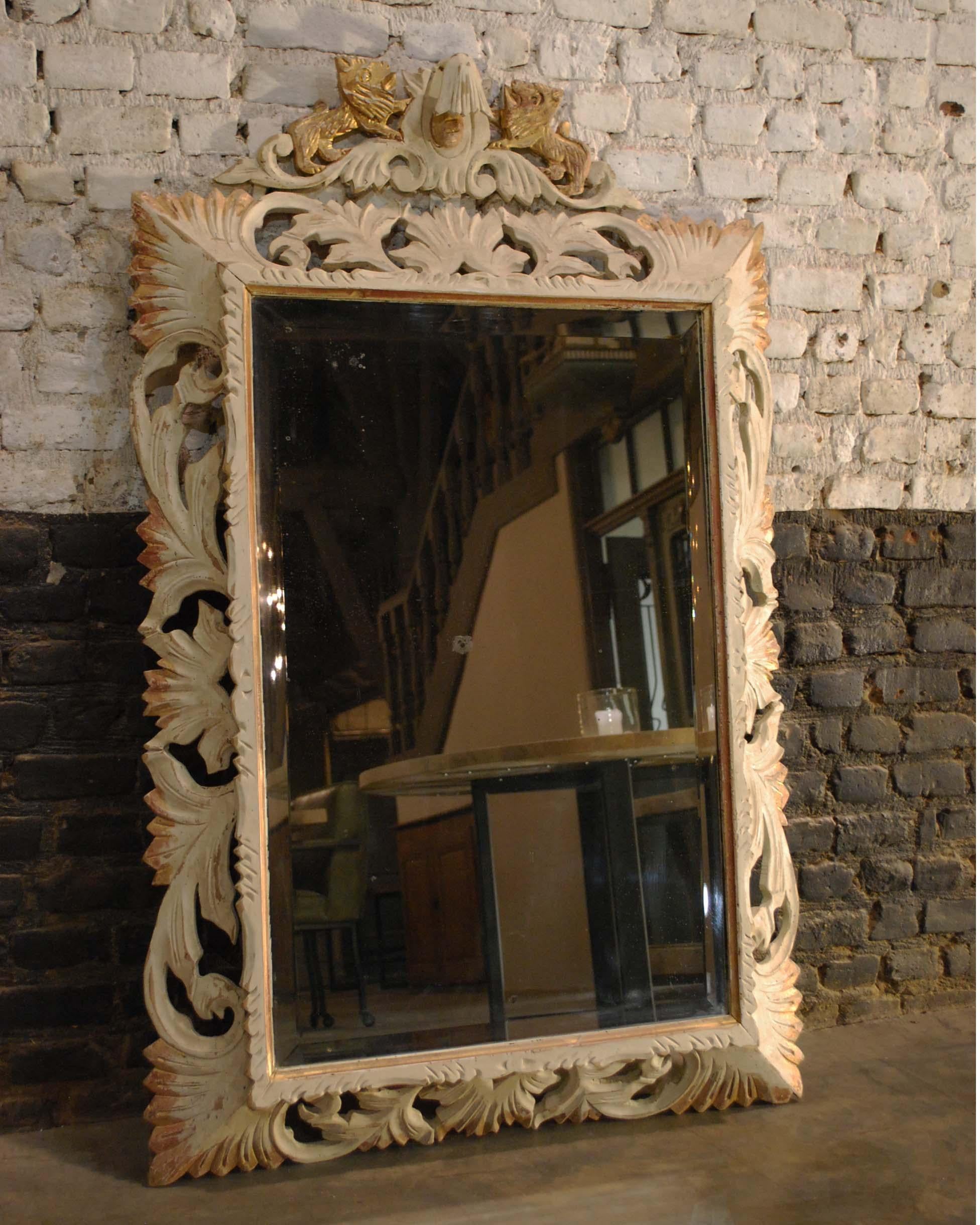 This beautiful mirror is made in Italy, circa 1900.
It has a pine frame with hand carved surroundings. The top central ornament is flanked by two lions. The Marzocco is the heraldic lion that is a symbol of Florence and was apparently the first