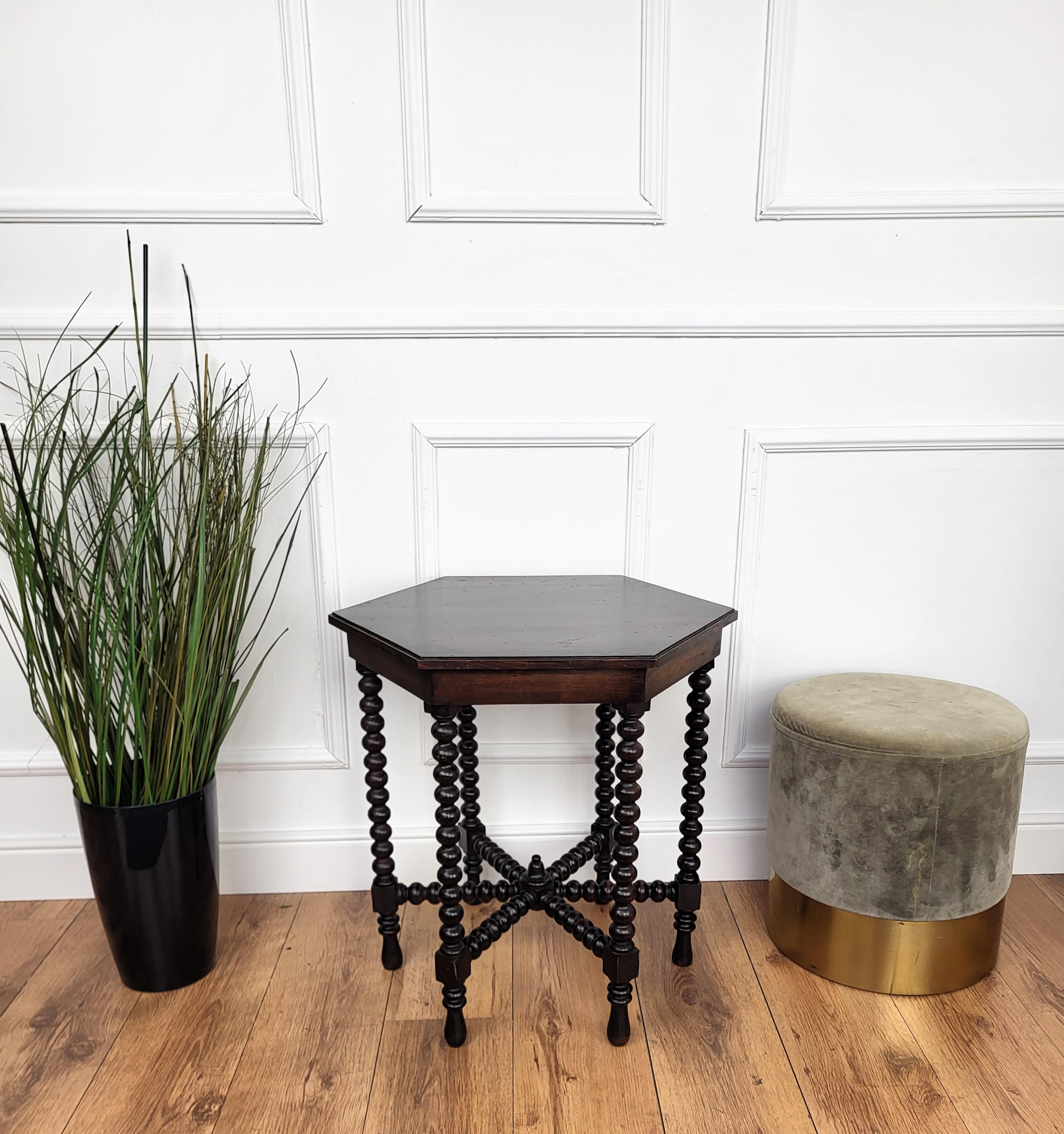 Beautiful antique Italian solid walnut side table, features hexagonal top with beveled edges over six beautifully bobbin turned legs, connected to one another with star shaped central stretcher. 
This Italian walnut side table or coffee table with