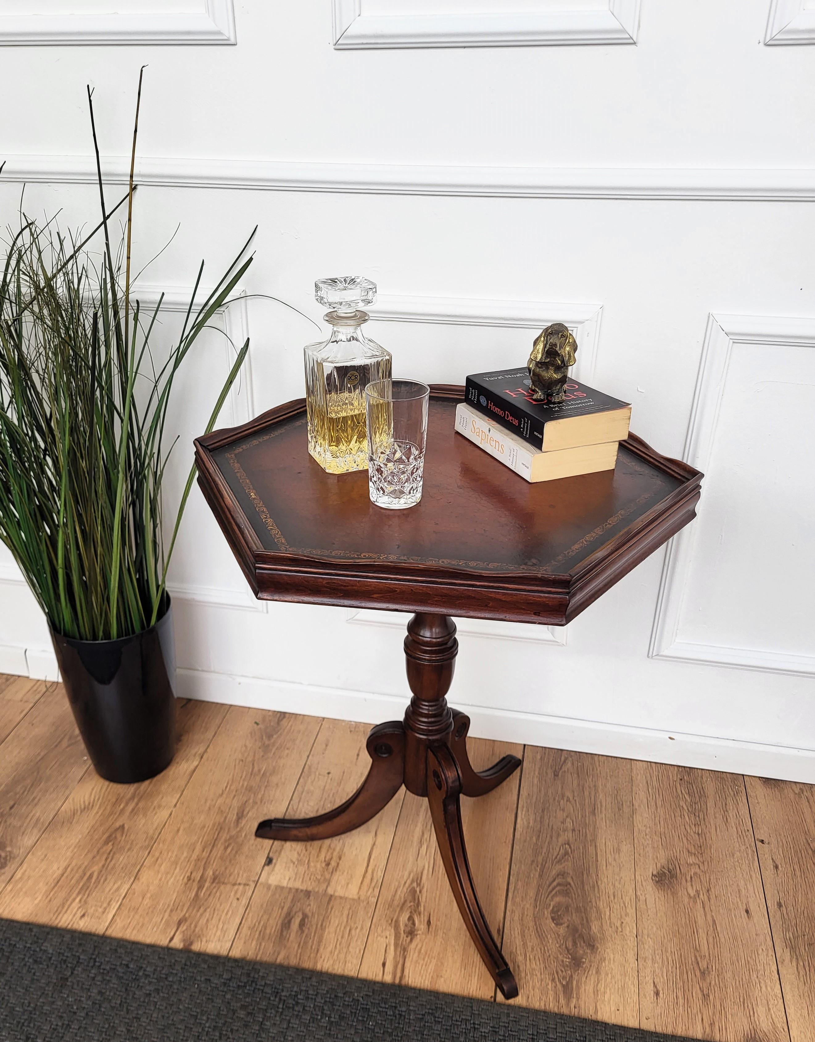 Beautiful and very elegant antique Italian solid walnut side table features an hexagonal top with gilt-framed leather standing on a central beautifully crafted leg and tripod feet. This Italian walnut side or coffee table with the rich and beautiful
