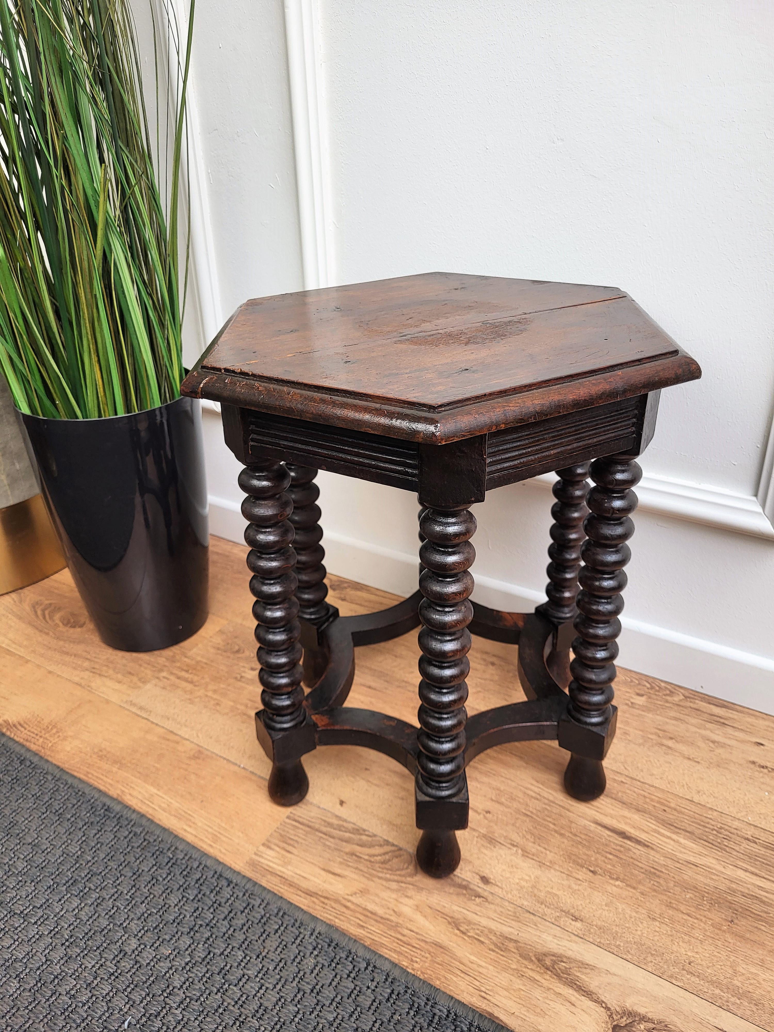 Beautiful antique Italian solid walnut side table or stool features hexagonal top with beveled edges over six beautifully bobbin turned legs, connected to one another with optogonal star shaped central stretcher. 
This Italian walnut stool or side