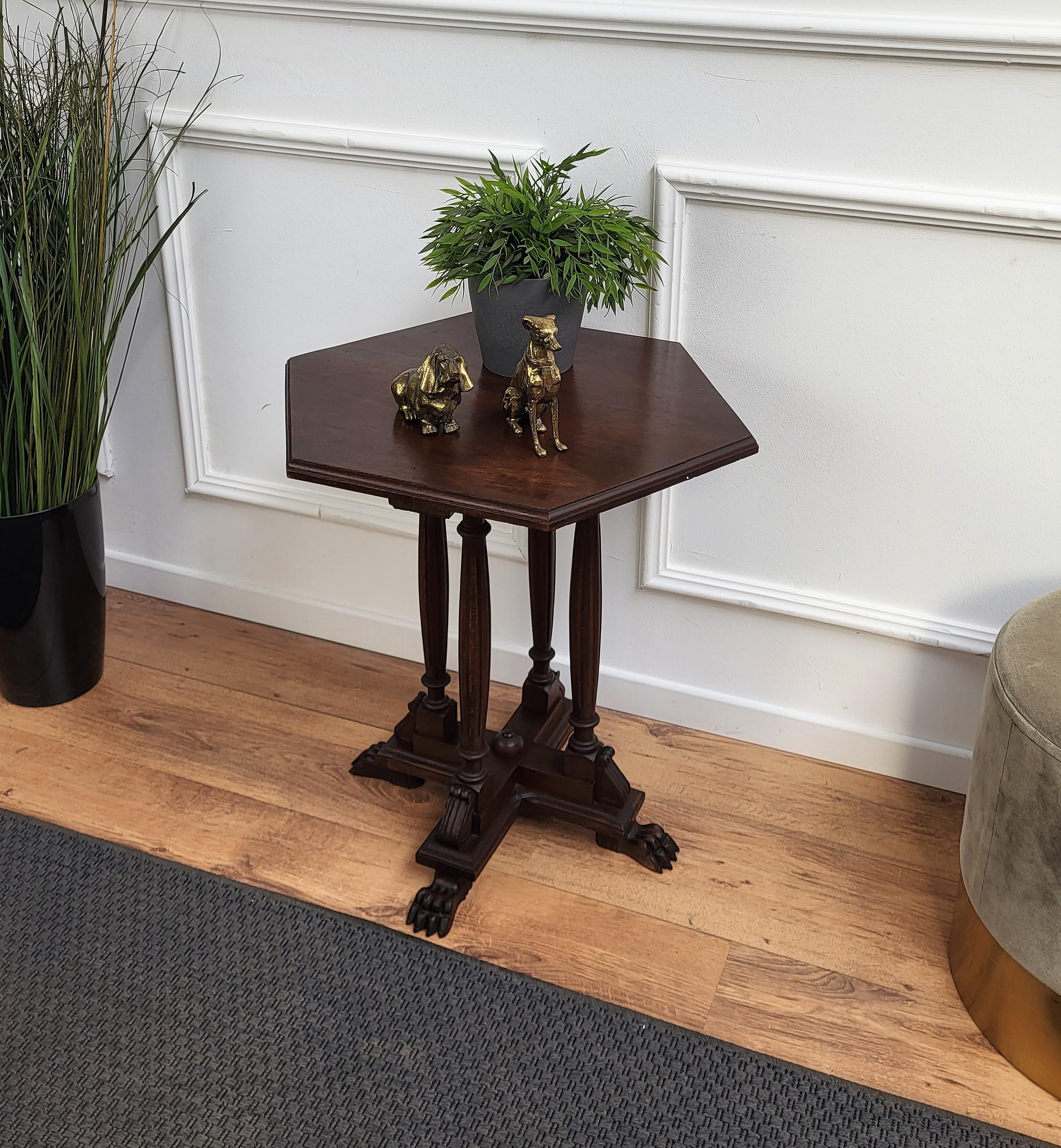 Beautiful antique Italian solid walnut side table or stool features hexagonal top with beveled edges over four beautifully carved legs, connected to one another with central star shaped stretcher and great animal foot ends.
 
This Italian walnut