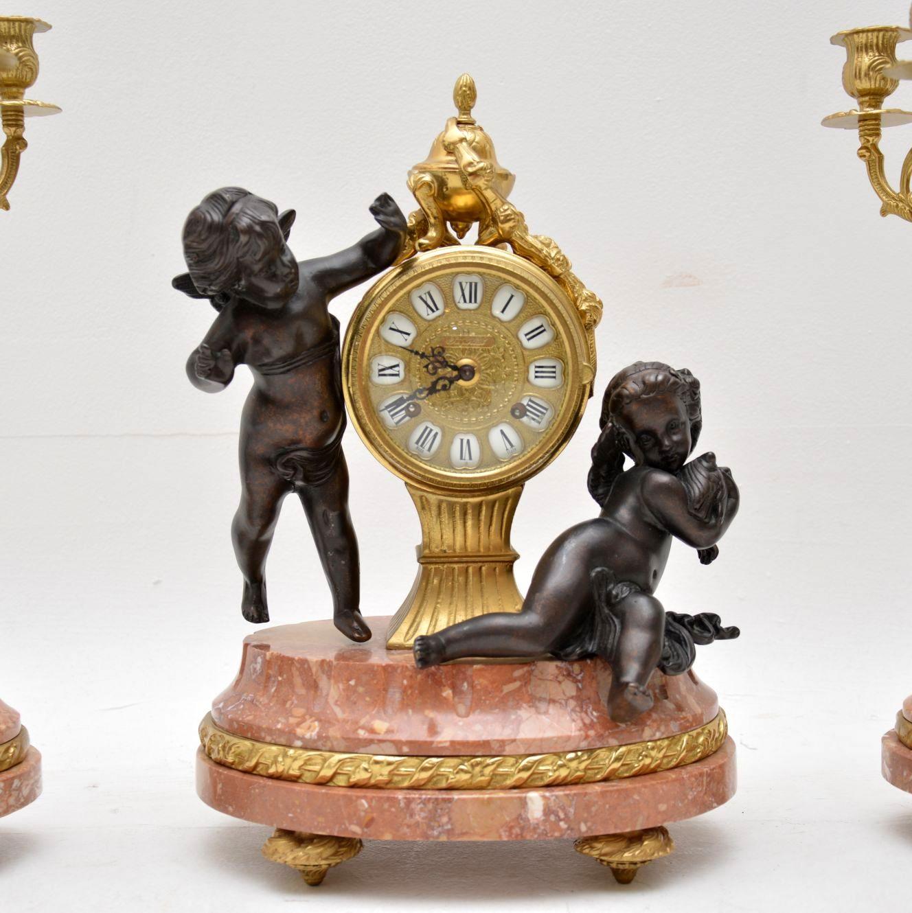 Antique French or Italian style clock and two matching candelabras in excellent condition. The clock is called an Imperial Clock and the movement is by “Franz Hermle”. The clock is in working order too and has a chime. They are very decorative