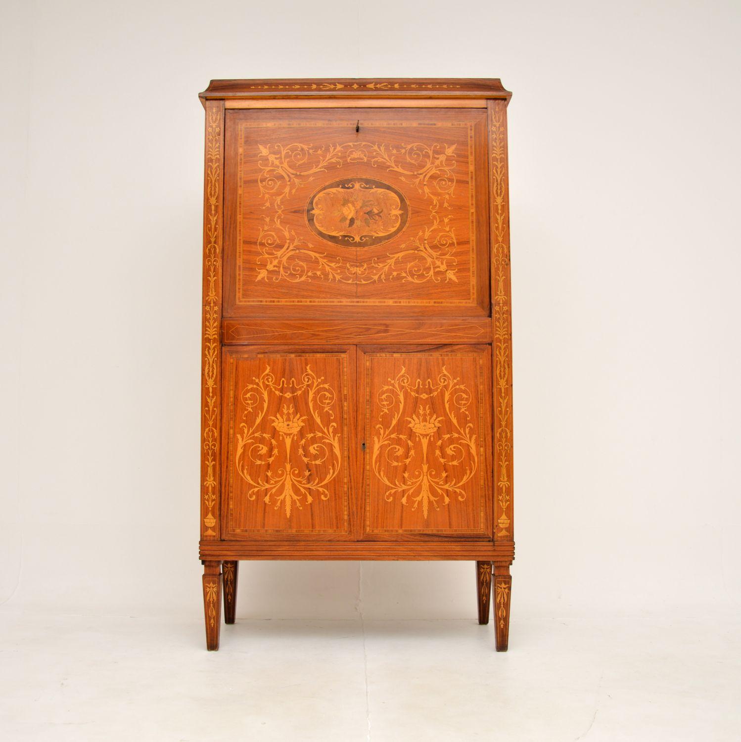 A superb antique Italian inlaid drinks cabinet in various woods. This dates from around the 1920’s.

It is of exceptional quality, with incredibly detail throughout. Even the inside surface of the drop down flap and insides of the lower doors have