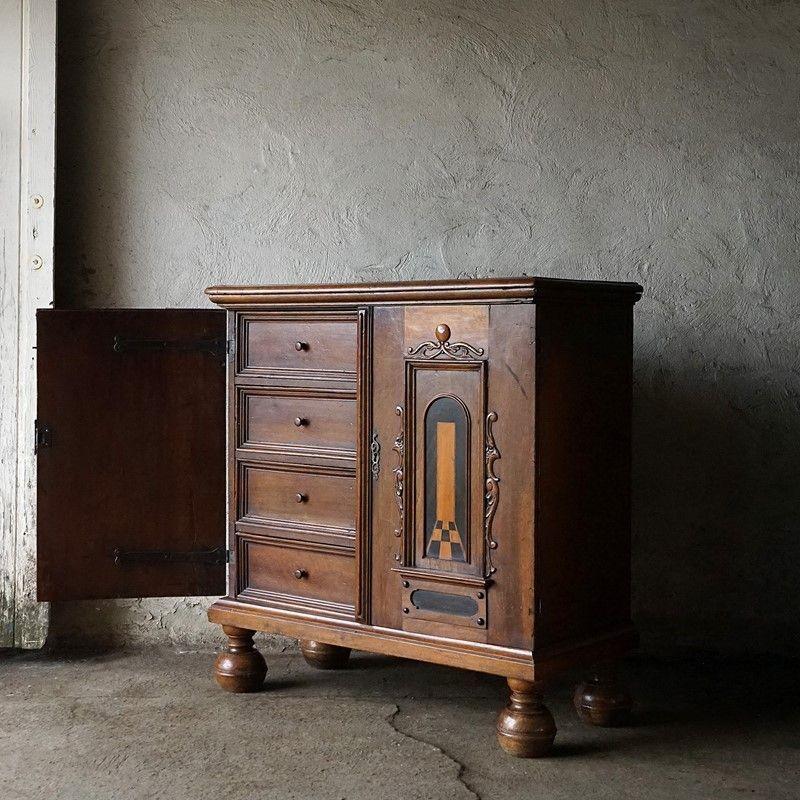 Antique Continental Cupboard With Fitted Interior and Marquetry Inlay
 
Twin doors have applied carved details surrounding an inlaid stylised pictorial design depicting a view through an archway.
 
Stepped chamfered edge top and stepped base over