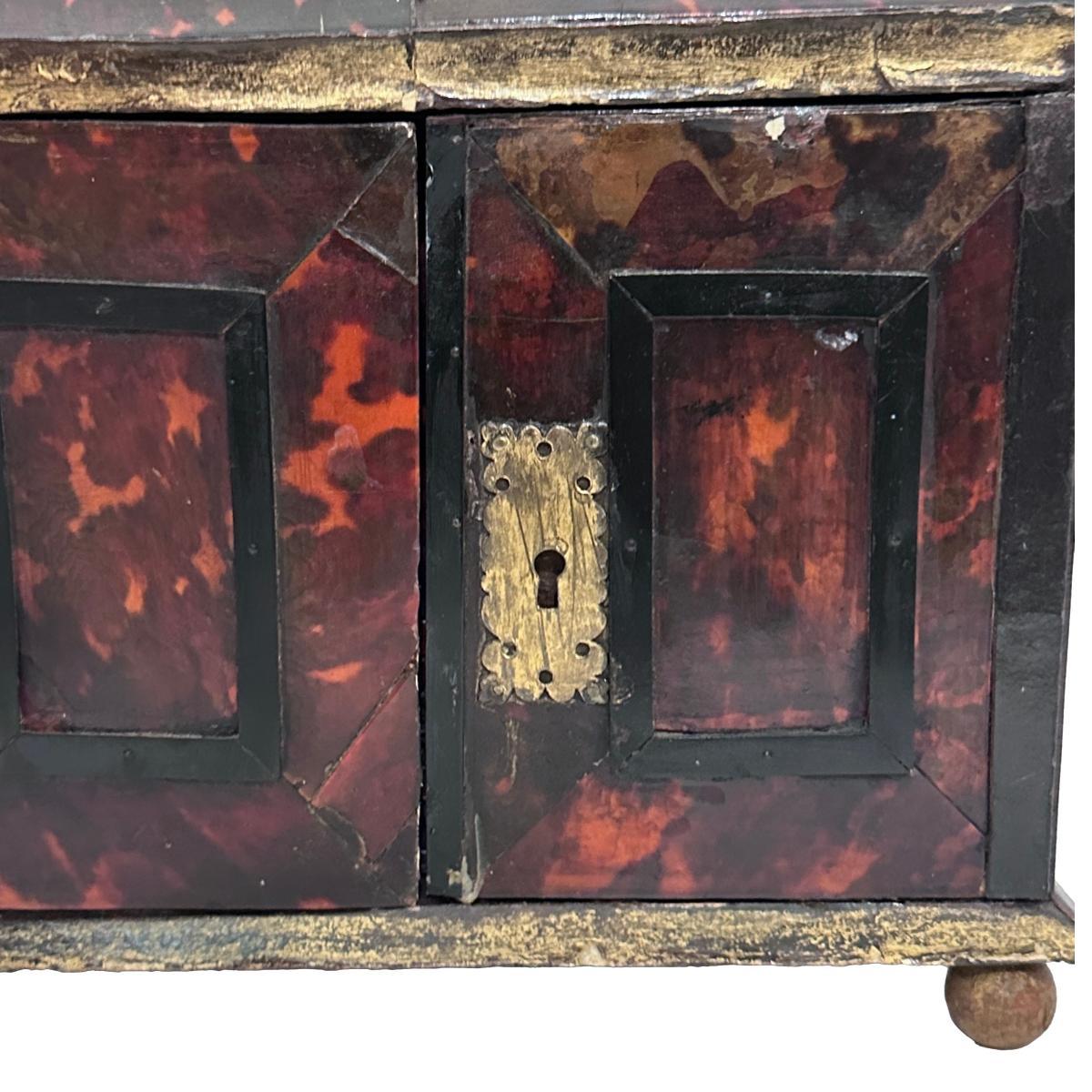 An Italian late 19th Century jewelry box with drawers and top compartment.

Measurements:
Height: 10