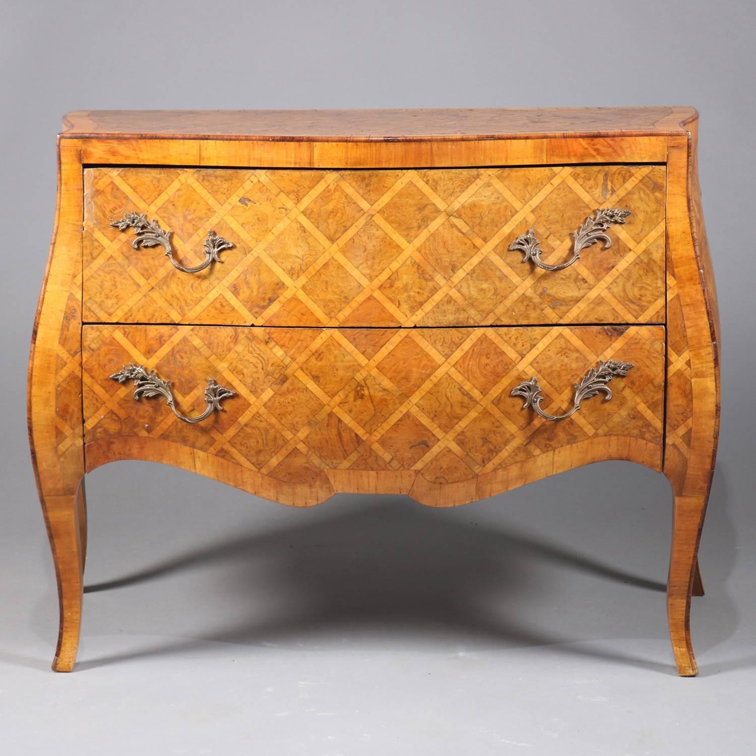 Antique Italian kingwood and burled parquetry two-drawer chest features Bombe form with scalloped skirt and raised on tapered cabriole legs, foliate form cast bronze pulls throughout, 20th century

Measures: 24.25