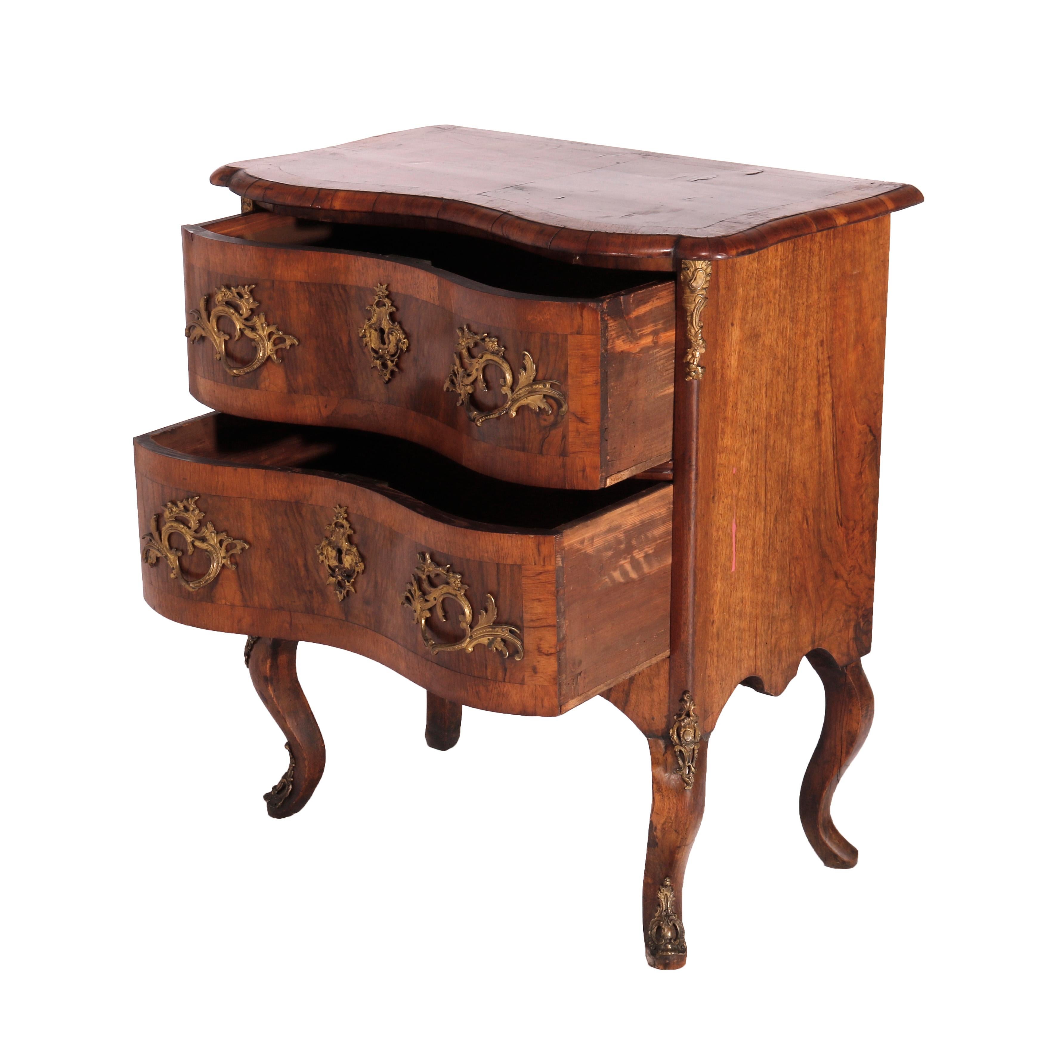An antique Italian side chest offers kingwood construction with satinwood inlay having shaped top over serpentine case with two crossbanded drawers, raised on cabriole legs; cast ormolu mounts throughout, late 18th century

Measures - 31.5