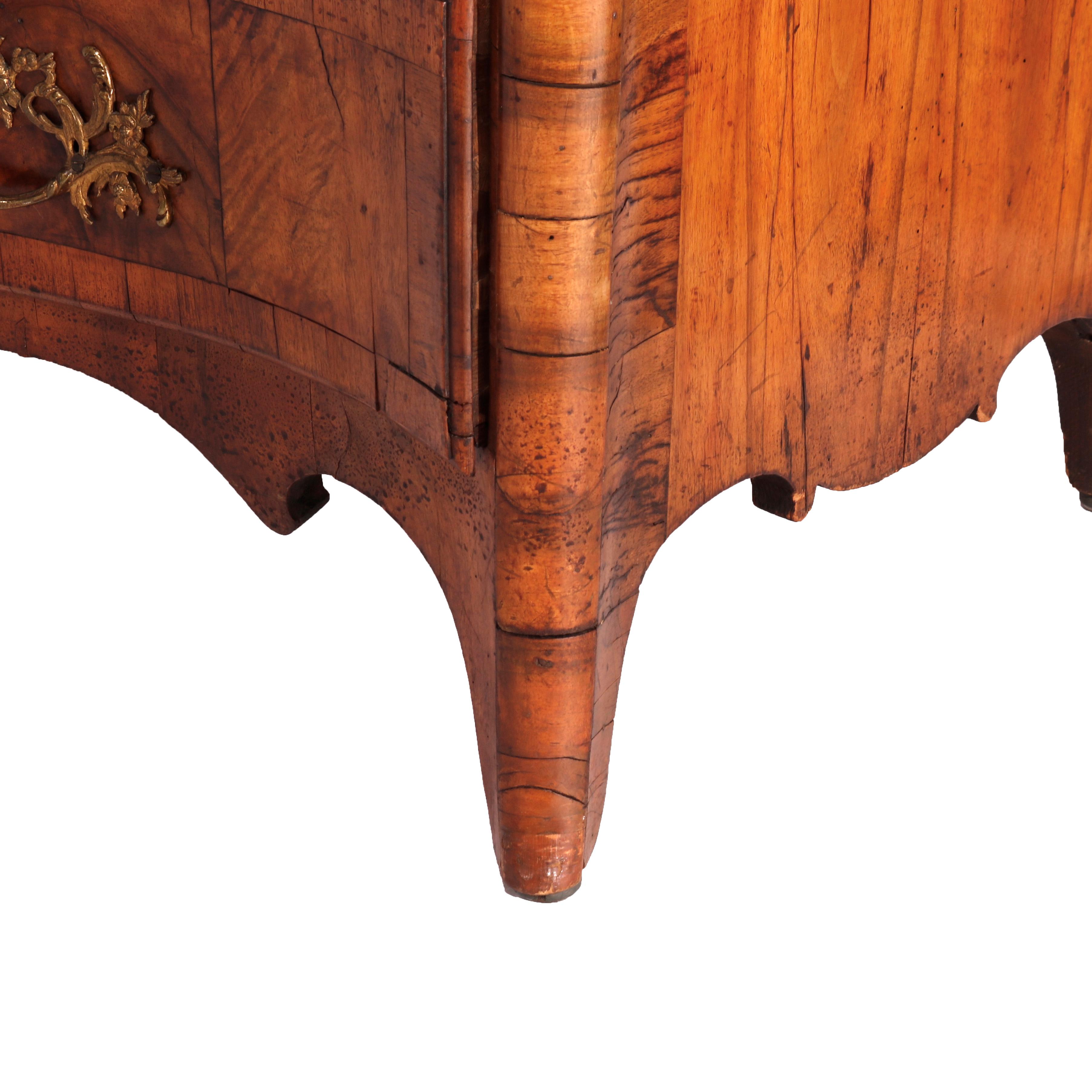 An antique Italian chest of drawers offers kingwood, satinwood and burl construction in bow-front form with cast ormolu mounts and having four banded drawers, raised on bracket feet, 18th/19th century

Measures - 33.75