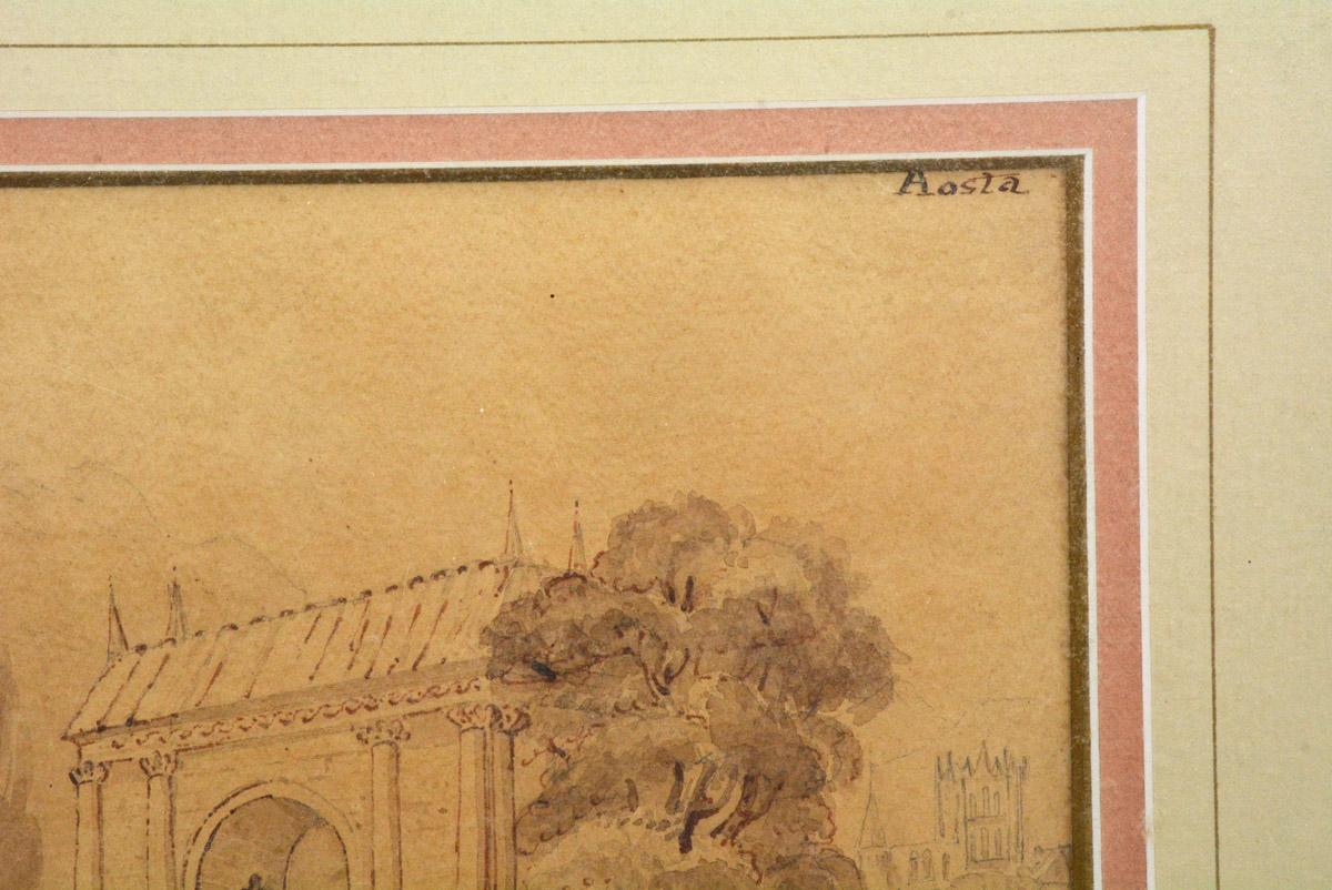 The antique Italian drawing in pen-and-ink and wash pictures a landscape of a stone bridge, archway, trees and people in the Renaissance style. The drawing is set within a two-tone double mat and gilt frame. The name 