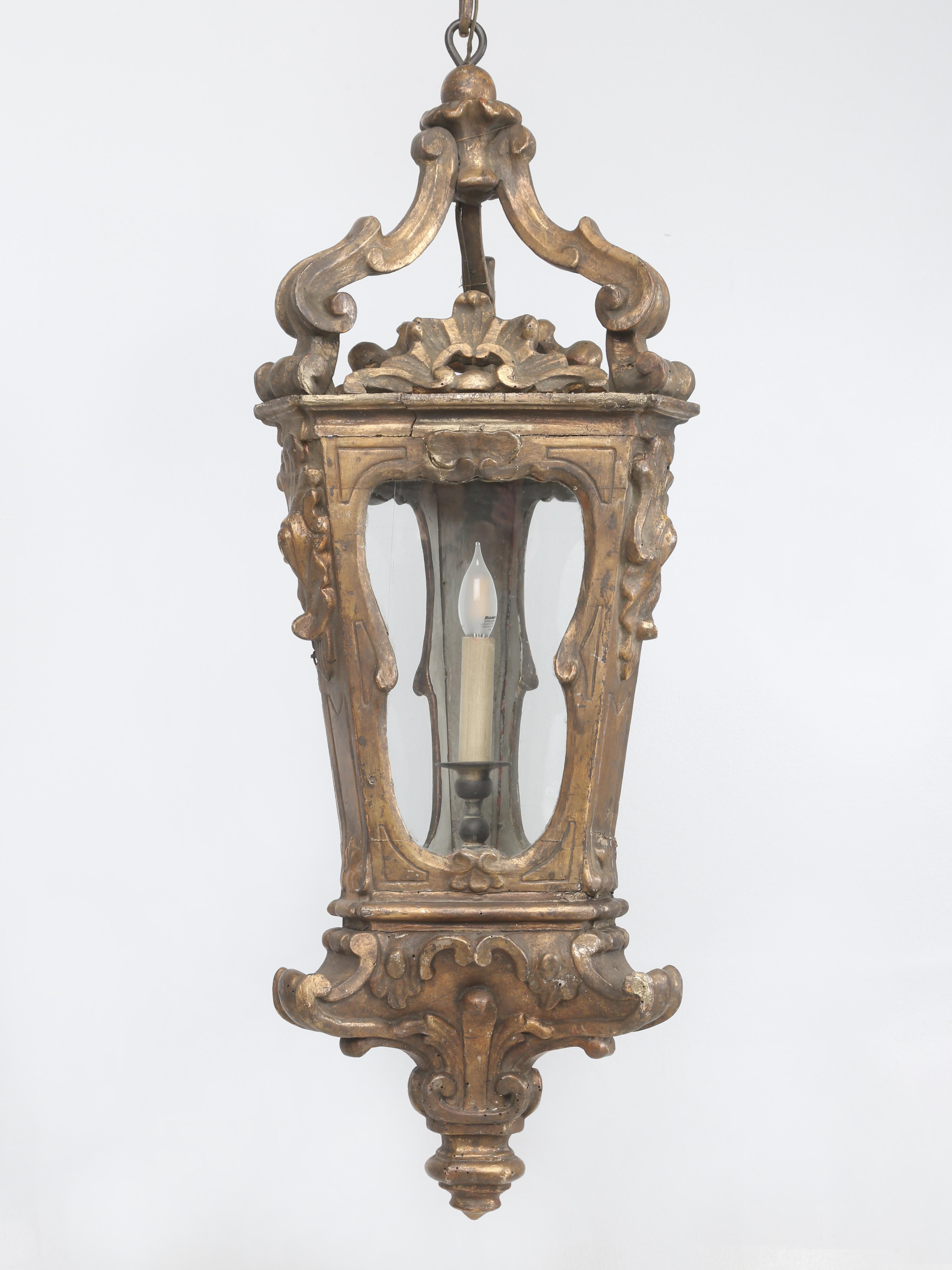 Antique Italian Lantern Hand-Carved over 250-Years Ago and remarkably does not appear to have ever been restored, only electrified a very long time ago. We had this Antique hand-carved Italian Gilded Wood Lantern hanging in the front entry for about