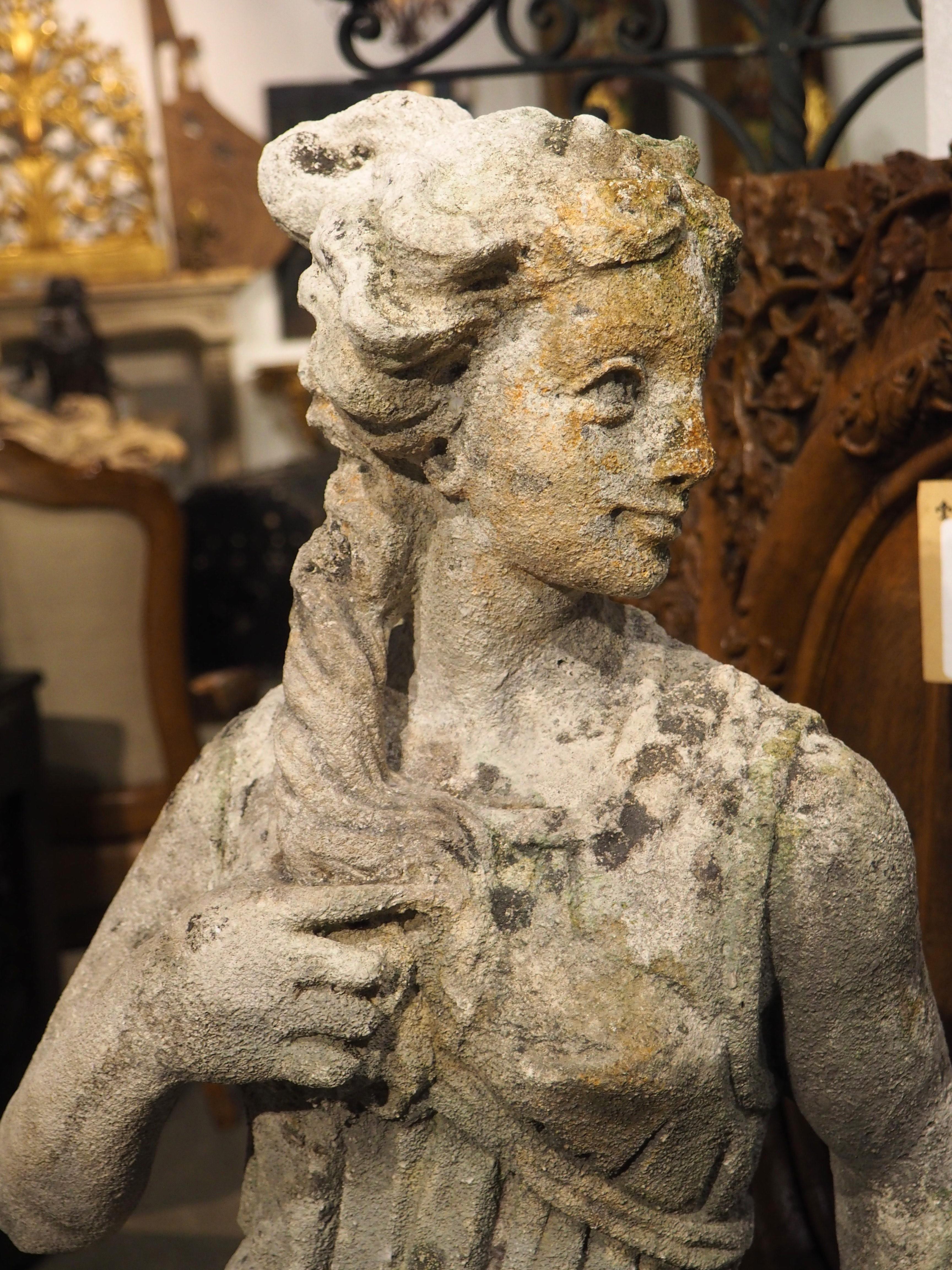 Hand-carved from Italian limestone, circa 1890, this beautiful Neoclassical statue is a unique interpretation of the famous Diana of Versailles statue (the 1st or 2nd-century marble, which is itself a copy of a lost bronze sculpture dating to 325