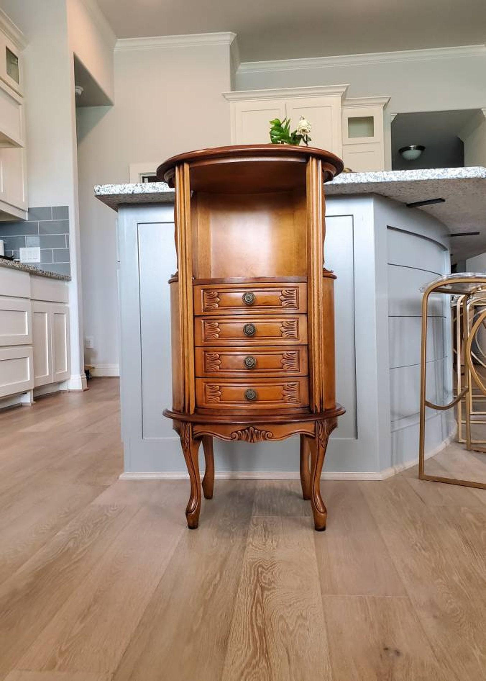 An elegant oval shaped side cabinet, born in northern Italy in the early 20th century, finished in sophisticatled and stylish Louis XV taste, with curves on all sides, lending to the gracefully flowing lines, oval form top over open niche shelf,