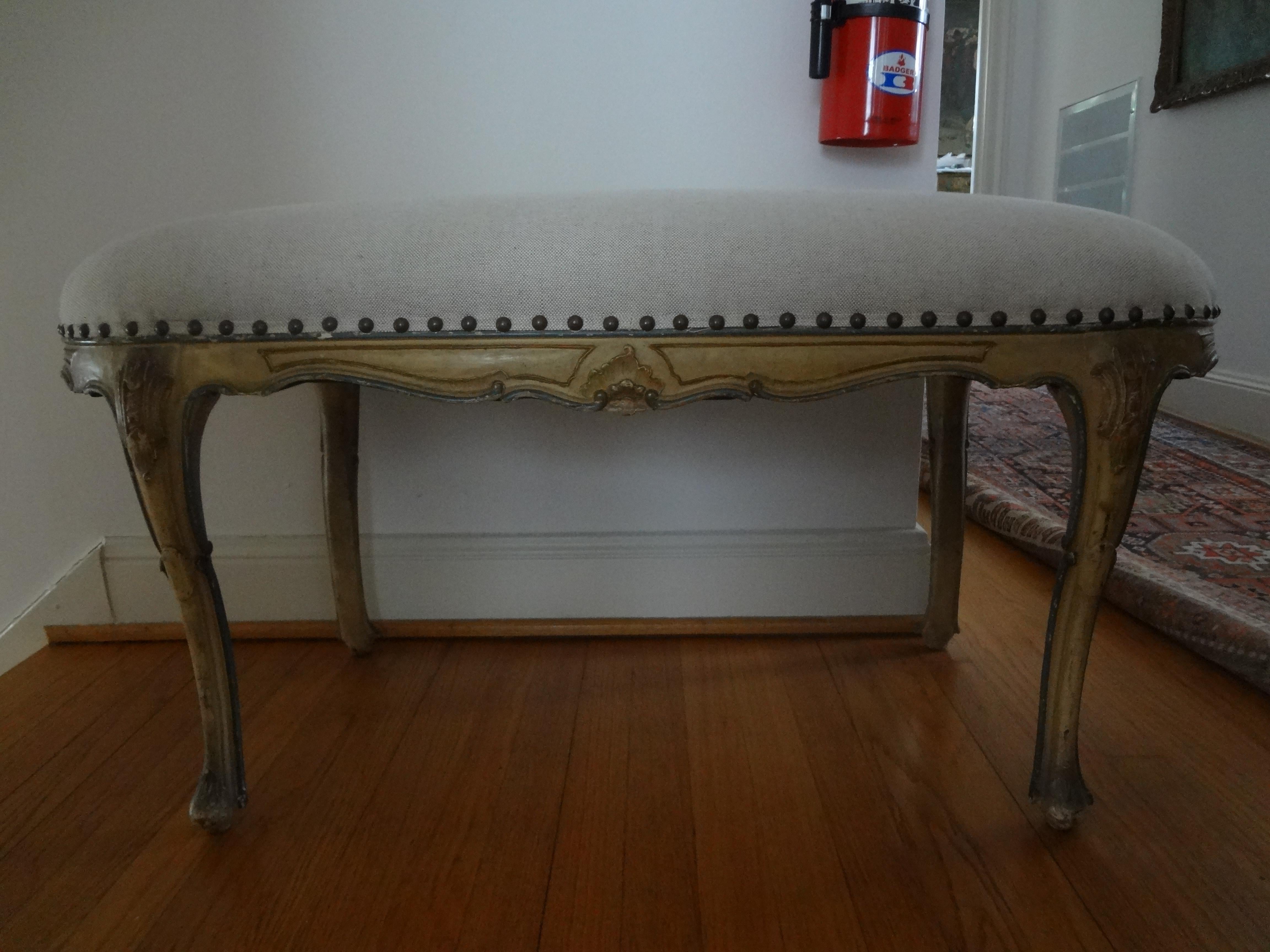Antique Italian Regence Louis XV style painted bench.
Lovely Italian painted bench from the 1920s. This unusual antique Italian Regence-Louis XV style oval bench has been taken down to the frame and professionally upholstered in neutral oatmeal