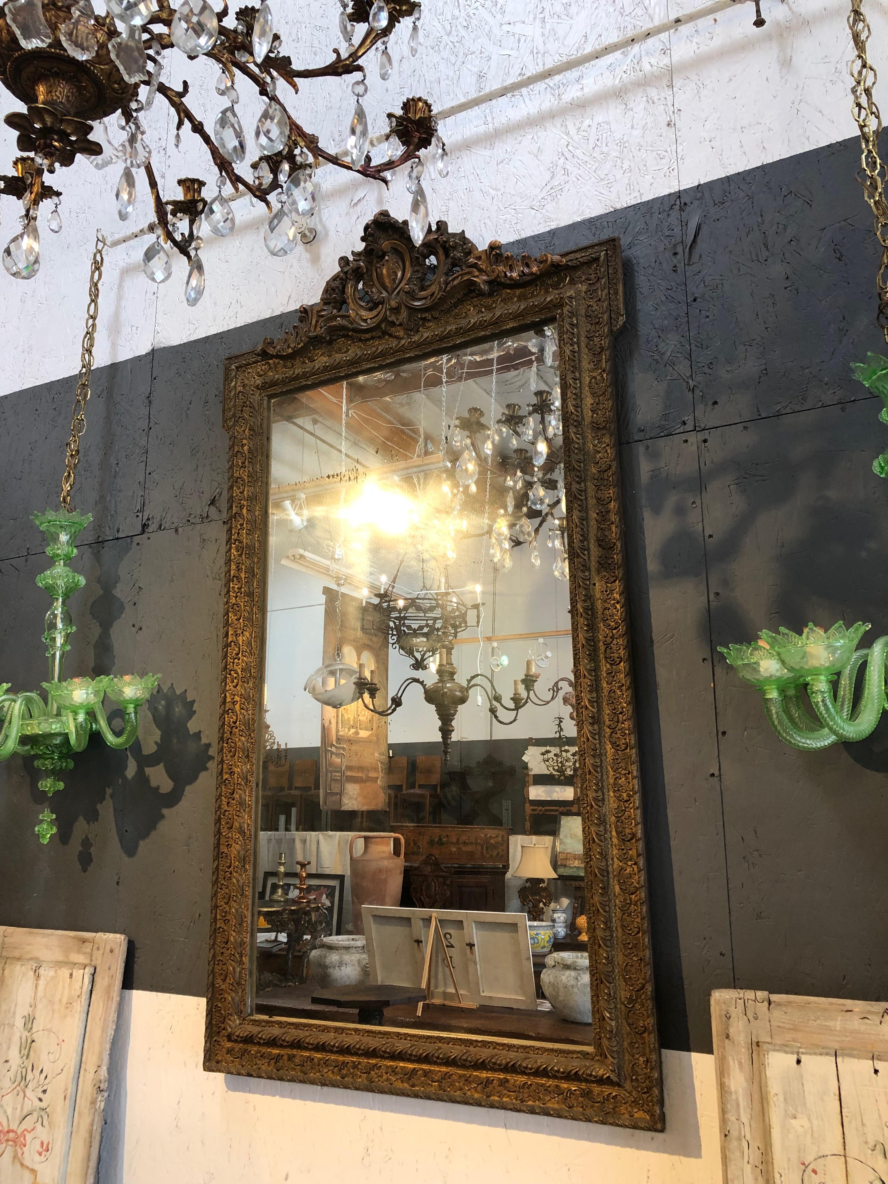 Lovely, large Baroque mirror with hand-carved top detail including central corazon or heart shape, and pastille gold painted vertical frame.  

Measures: 62