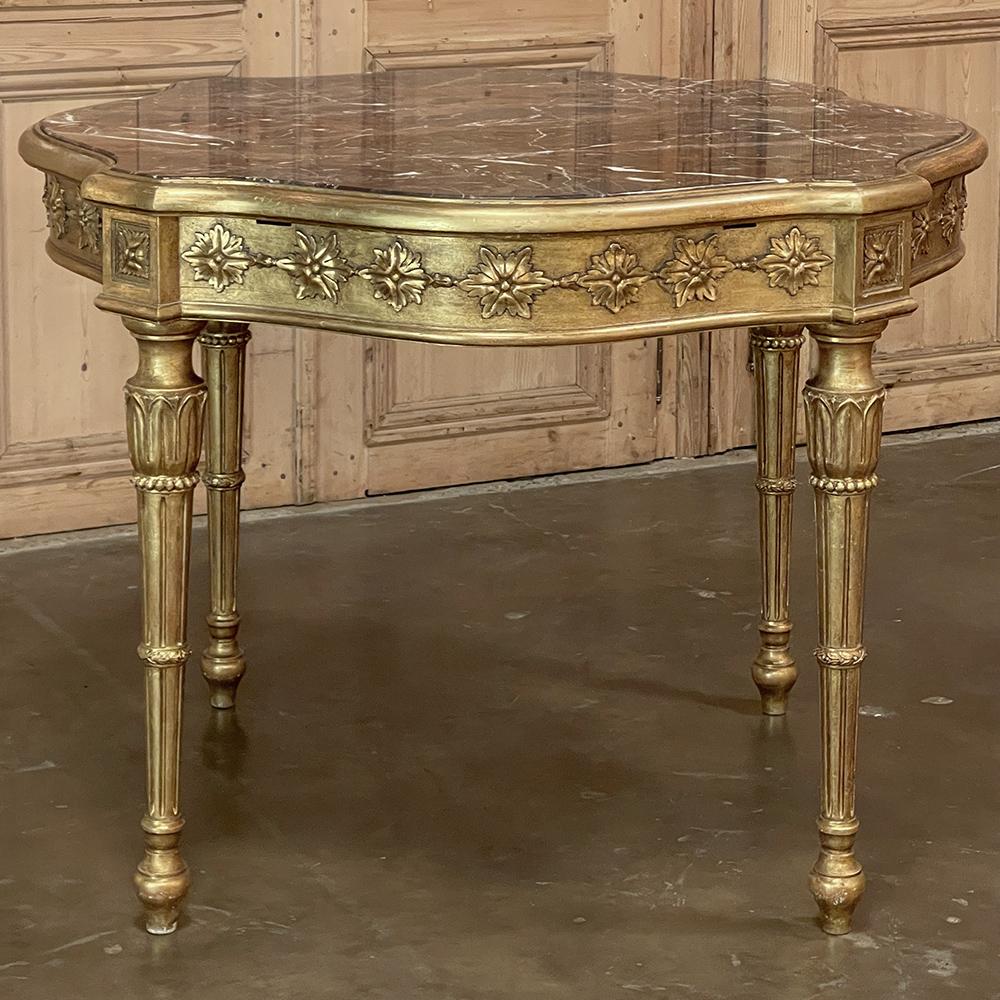 Antique Italian Louis XVI neoclassical Giltwood marble top center table is literally artwork expressed as furniture! The shield shape that is evident when viewed from above emphasizes four squared projections under which appear plinth blocks with