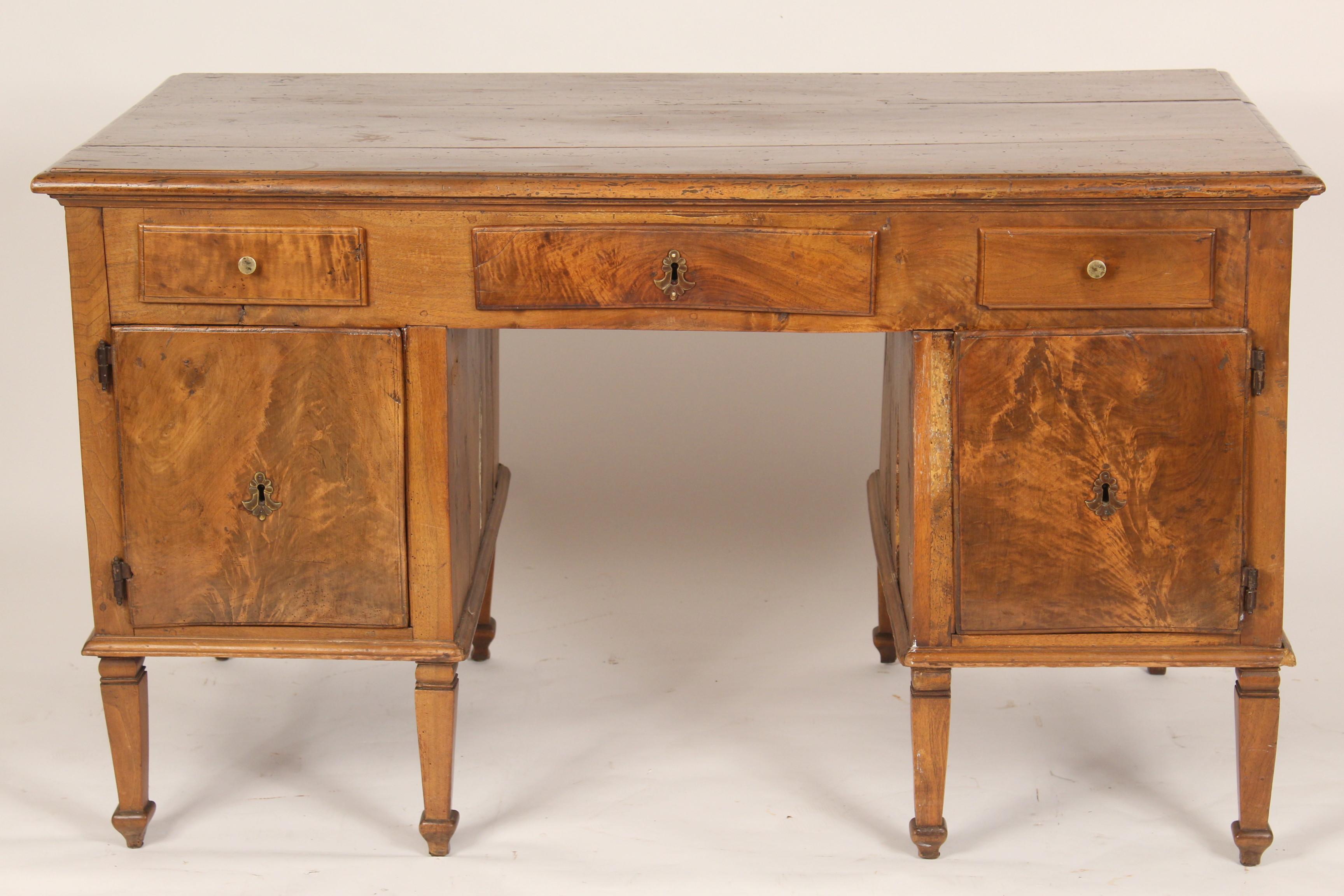 Antique Louis XVI style walnut double pedestal desk, 19th century. Back side of desk has false drawer fronts and doors so desk can be floated in the center of a room. Knee clearance, height 23.25