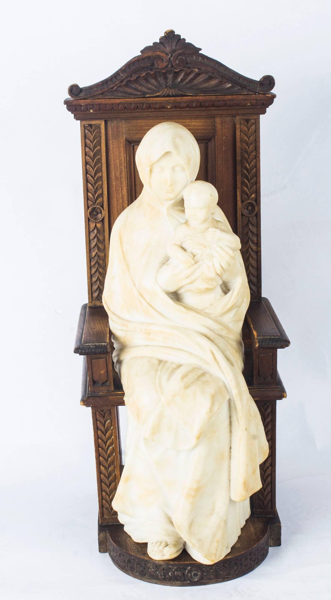 A superb large antique Italian marble sculpture of Madonna and child seated on an oak throne, signed and dated G.Gamilo '97, for 1897, to the base.

This delicately carved Carrara marble sculpture features the Nikopoia or Madonna dressed in long