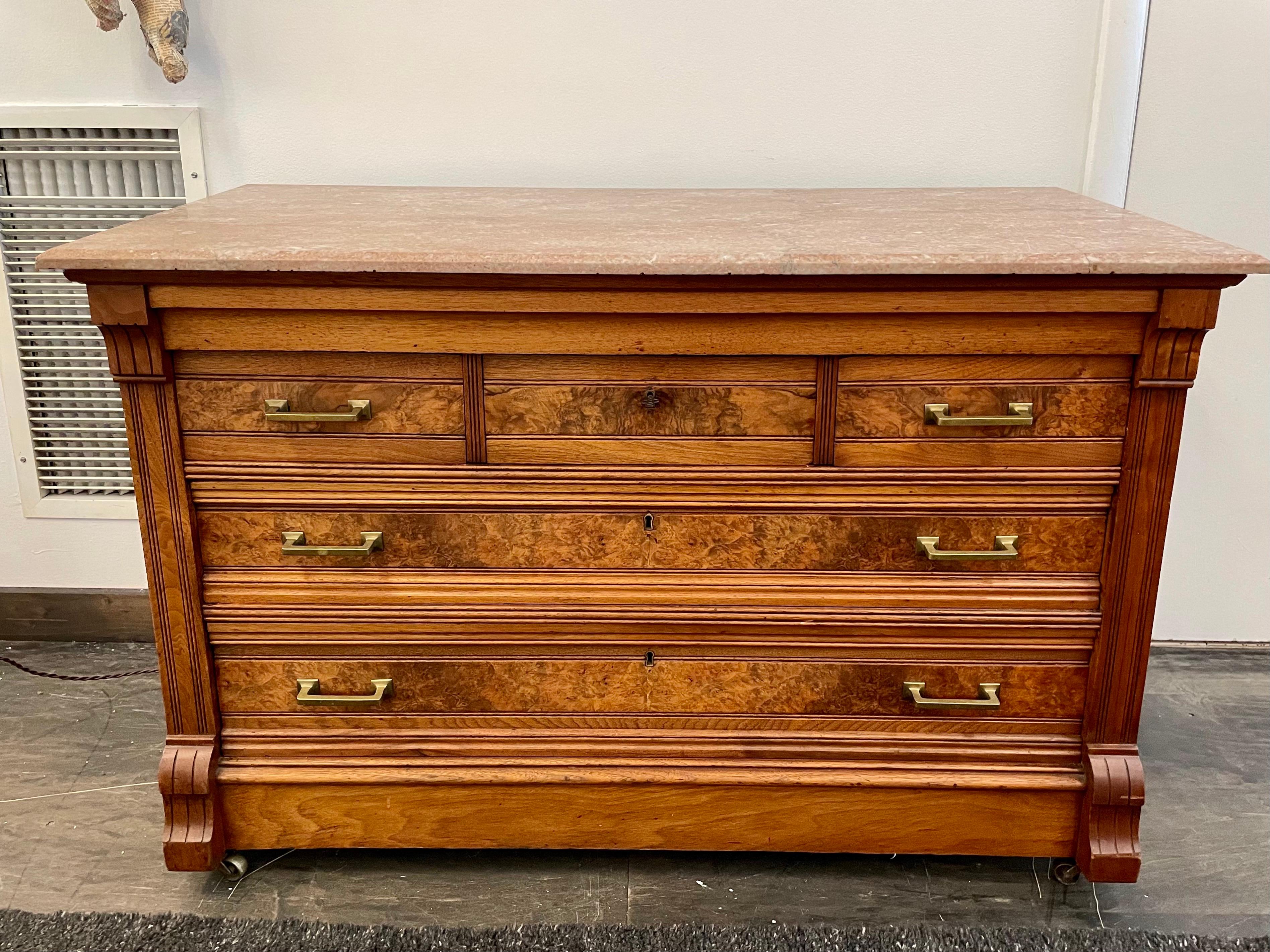 This wonderful piece is on casters with ALL original hardware. Top three drawers are felt lined with compartments - total of five drawers. Pink marble top is also original and beautiful. Burled wood veneer to façade of cabinet. This fabulous Italian