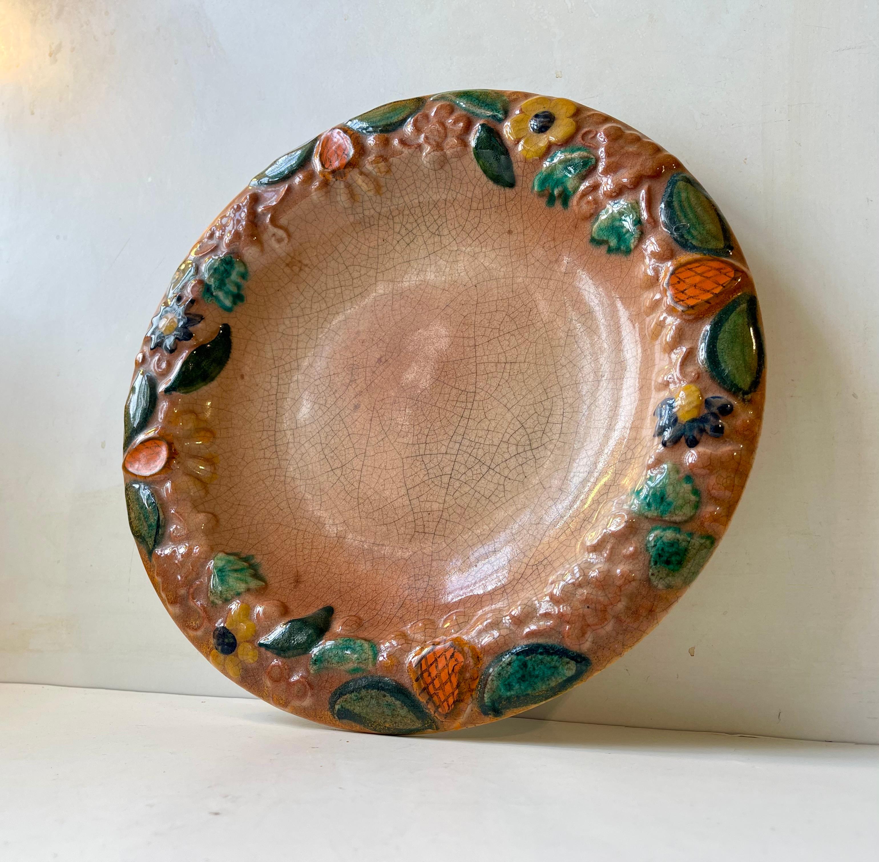 Gran plato de cerámica Plato de mayólica juguetonamente decorado con frutas, uvas y flores en todo su perímetro. Fabricante italiano desconocido, hacia 1910-20, en un estilo que recuerda a las primeras Clarice Cliff y Sarreguemines de Francia.