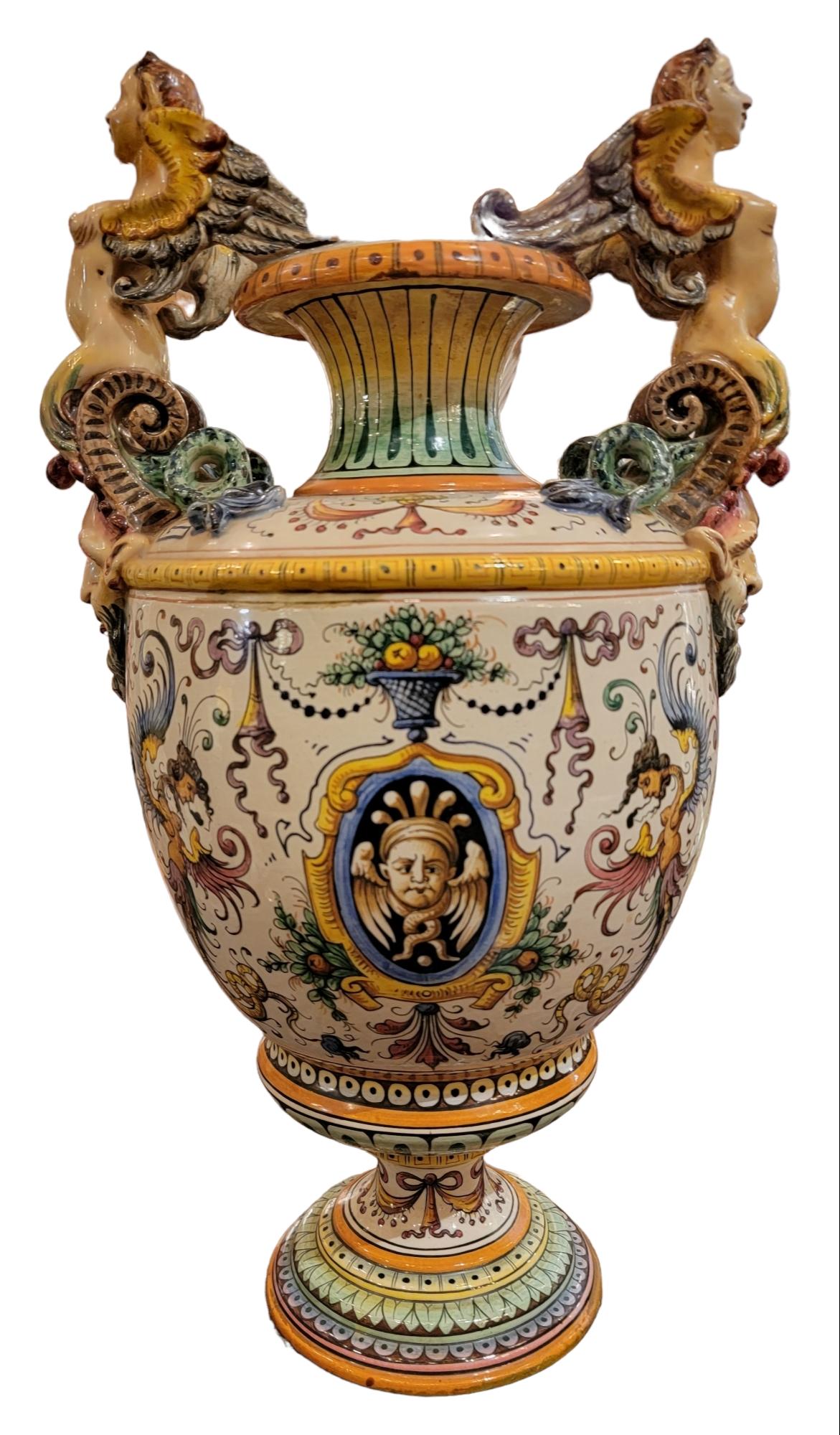 Antique Italian Majolica Ornate Urns. Wonderful Italian Majolica beautiful colors and designs. The serpentine woman handles ad a wonderful touch of power to the look.
