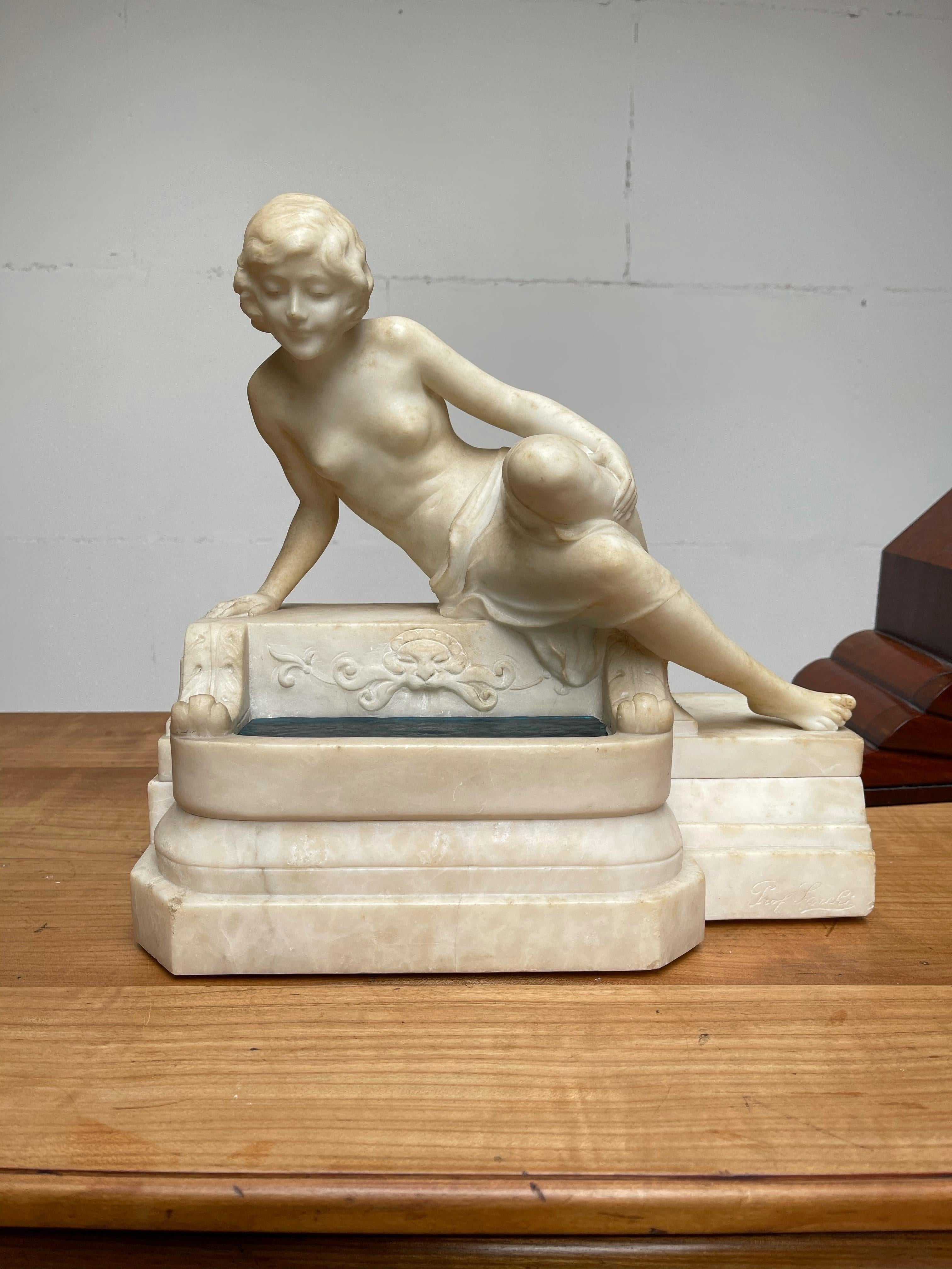 Hand carved white marble sculpture of a sitting maiden by a water well. By Emilio Fiaschi, Florence circa 1910.

This beautiful, impressive and elegant, sculptural table or desk lamp is another great find, because of its quality workmanship, its