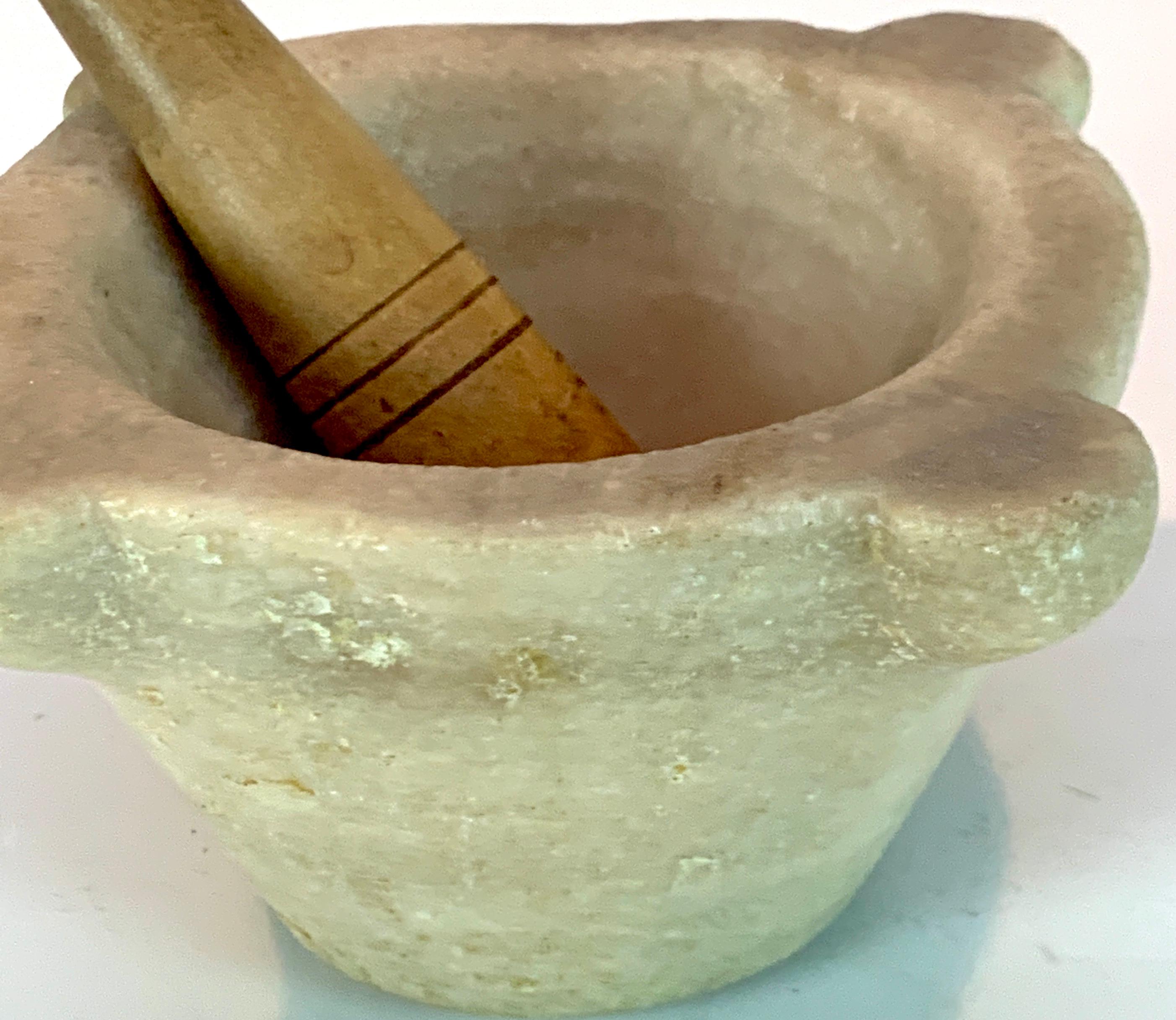 Antique Italian marble mortar and pestle, the mortar measures 6-inches in diameter x 4-inches high
with a carved drain spout. The interior measures 4.5- inches in diameter x 4- inches deep. The pestal (later) measures 7-inches long x 1.75 -inch