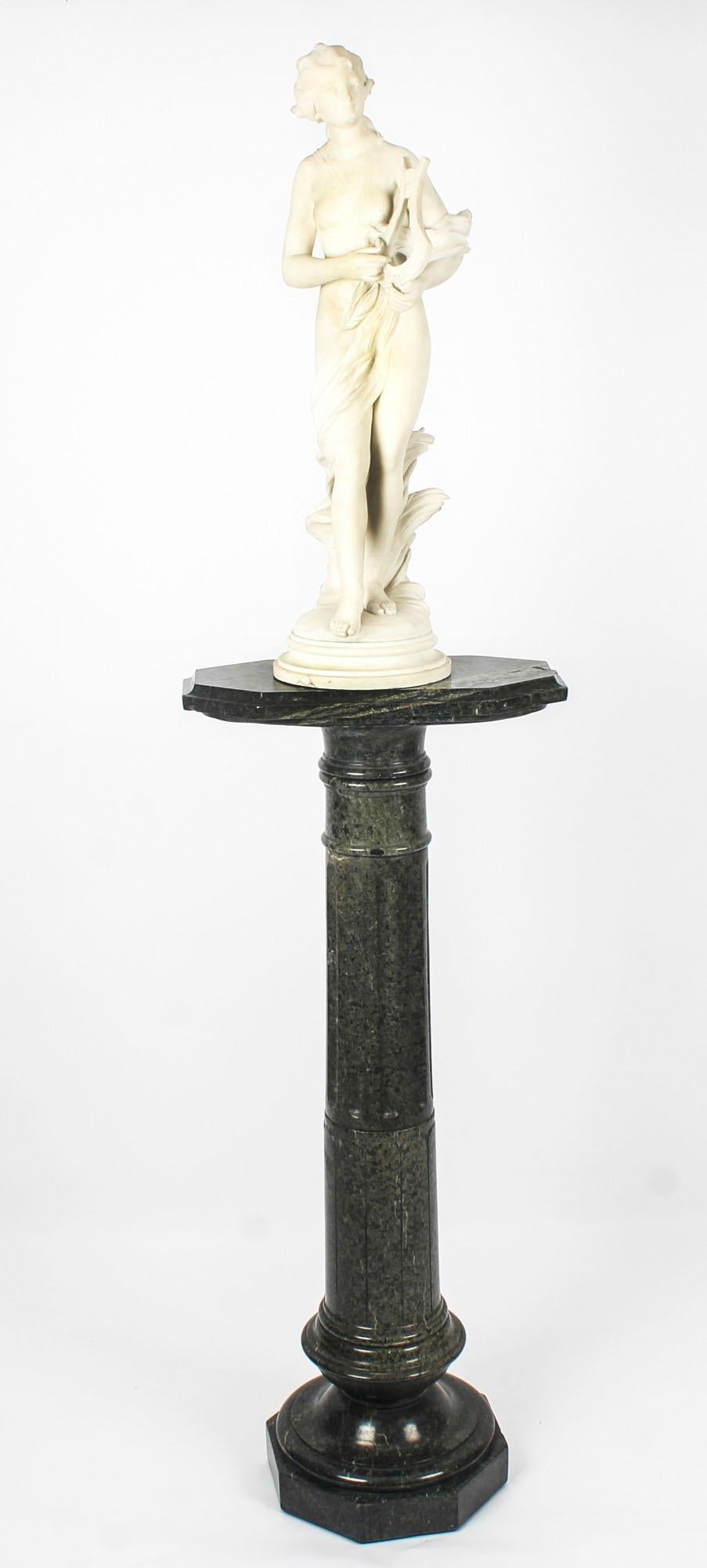 This beautiful Italian white Carrara marble sculpture of terpsichore bears the signature of the sculptor, T.Dini and late 19th century in date. It is raised on a stunning antique serpentine marble pedestal. This sensitively carved sculpture depicts