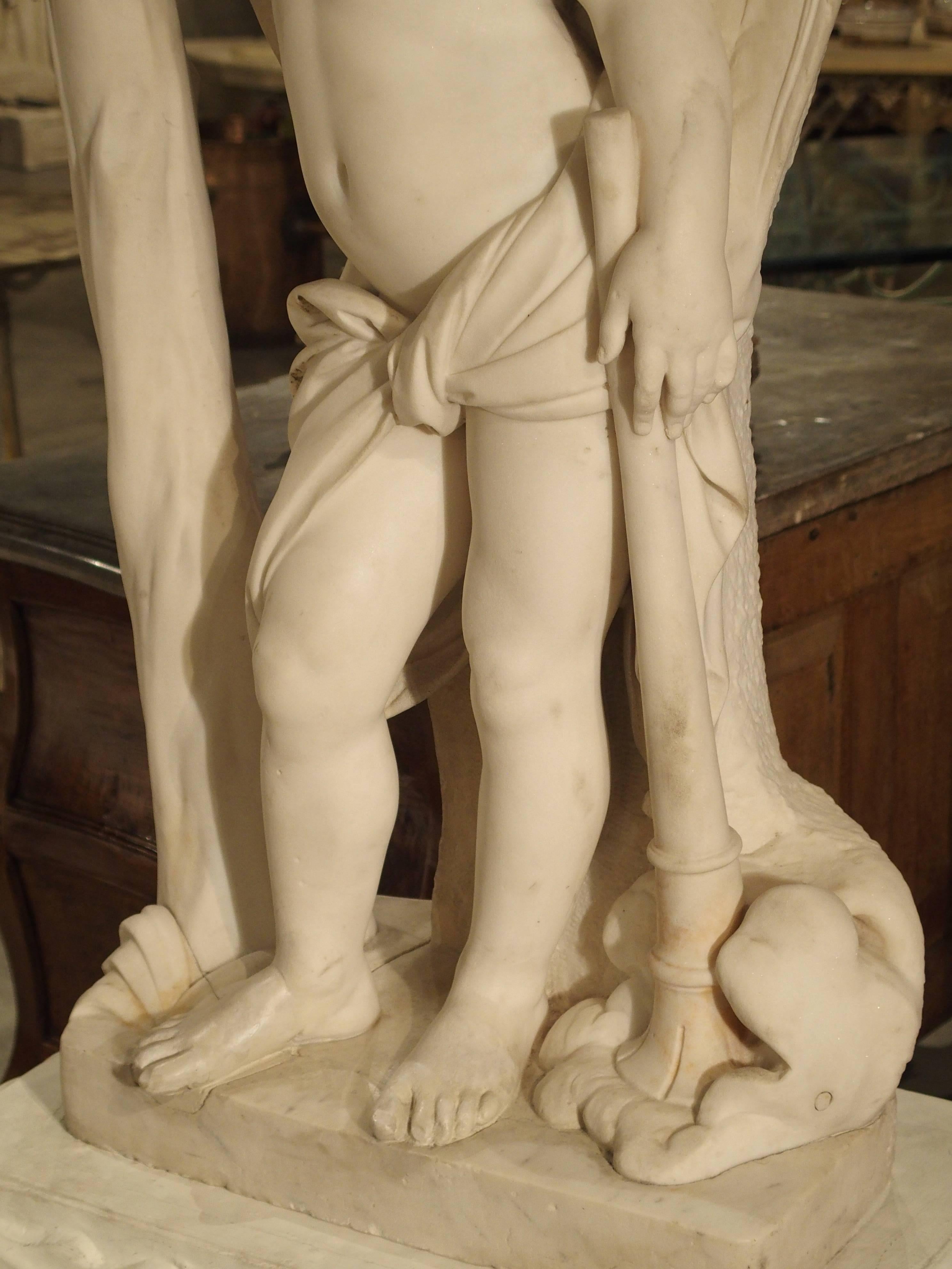 This beautiful antique marble statue from Italy depicts a musical cherub with his trumpet resting in a cloud. He appears to be taking a rest or time out from his usually busy musical activities. His right arm is supporting his head, while his eyes