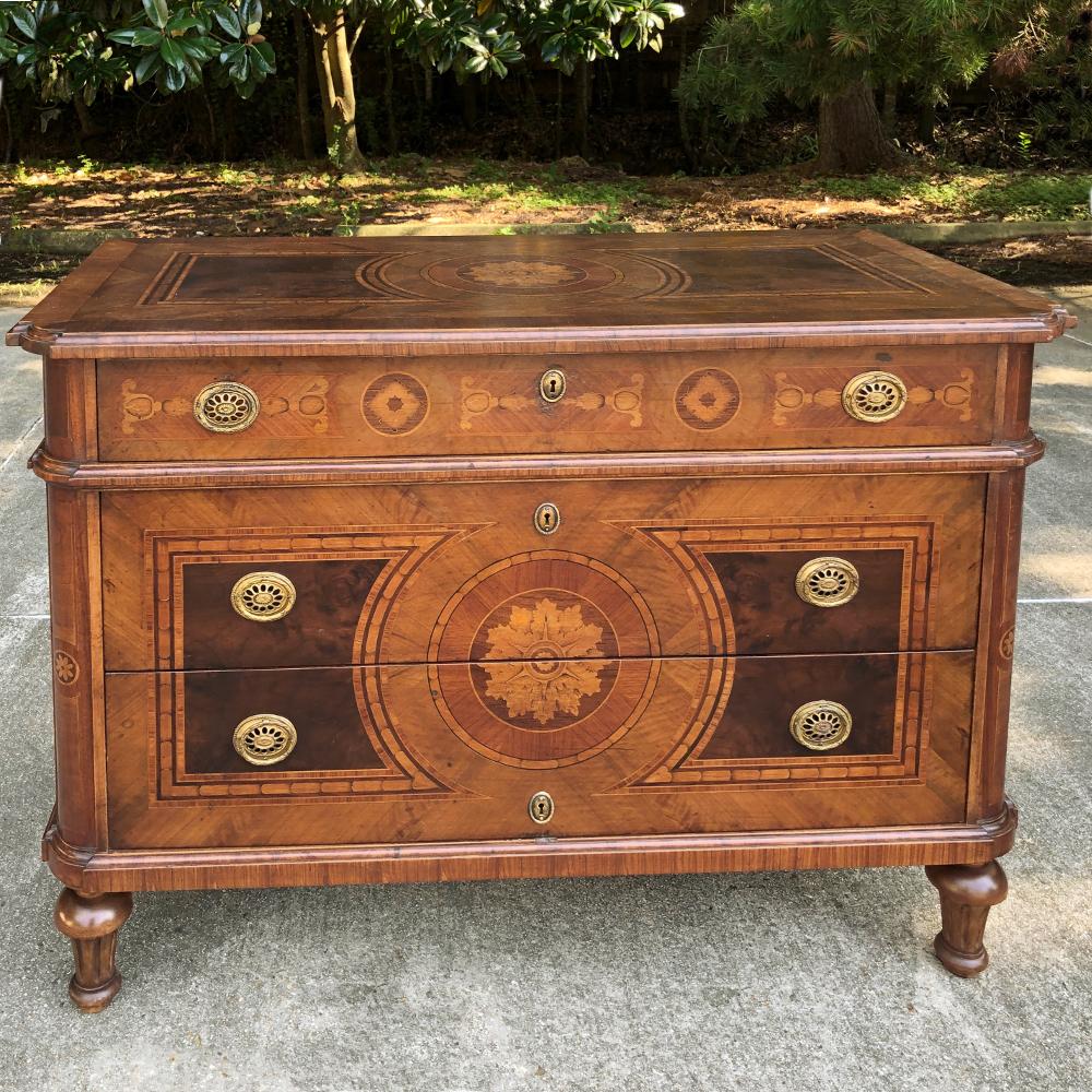 Antique Italian marquetry commode is a splendid example of the master woodcrafter's art! Fine mahogany was used as a base into which satinwood, walnut and other woods were inlaid in an artistic pattern known as marquetry. Even the top surface is