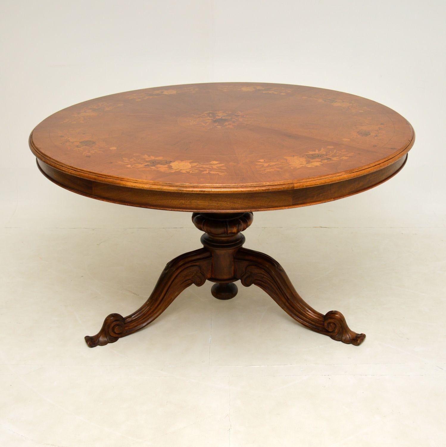 A superb antique circular dining table, beautifully made in walnut with profuse floral marquetry on a segmented top. This was made in Italy & I would date it from around the 1930’s period.

The quality is absolutely fantastic and this is a great