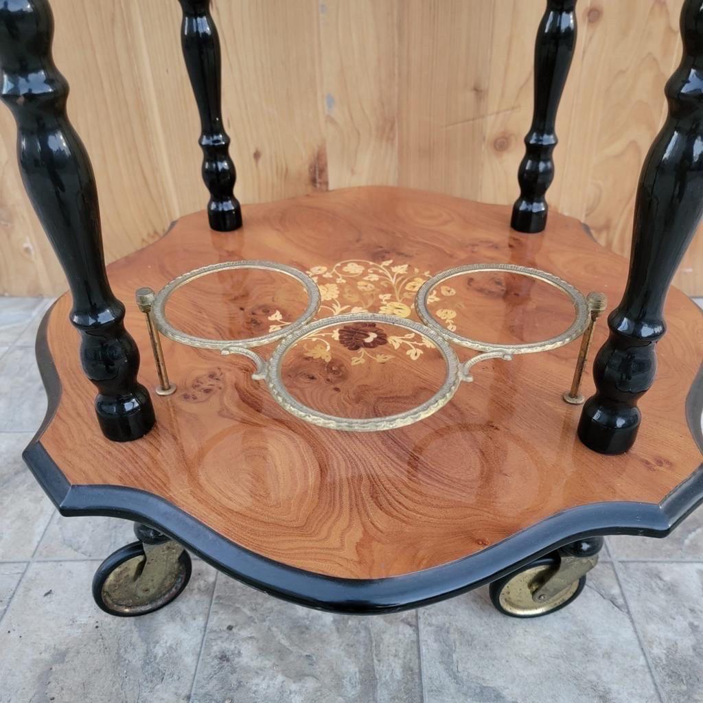Antique Italian Marquetry two-tier coffee/bar cart

Beautiful 1960's Italian bar cart or tea/coffee trolley with inlaid marquetry. Wheels and push handle makes it super easy to move around as needed. Cart has a railed top and a 3-ring bottle