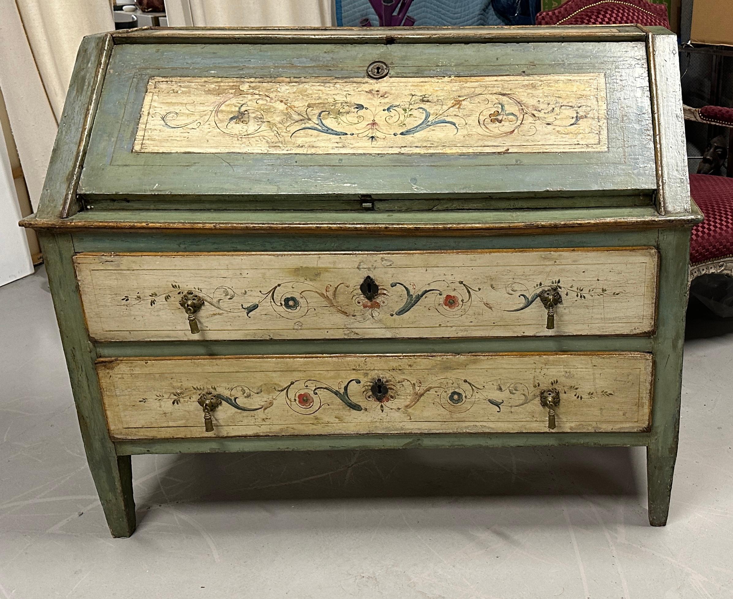 A beautiful 18th century painted northern Italian slant front desk. Wonderful aged patina. It features two large drawers underneath and a slant front top. The slanted front opens to reveal a writing surface and 4 drawers with a central open