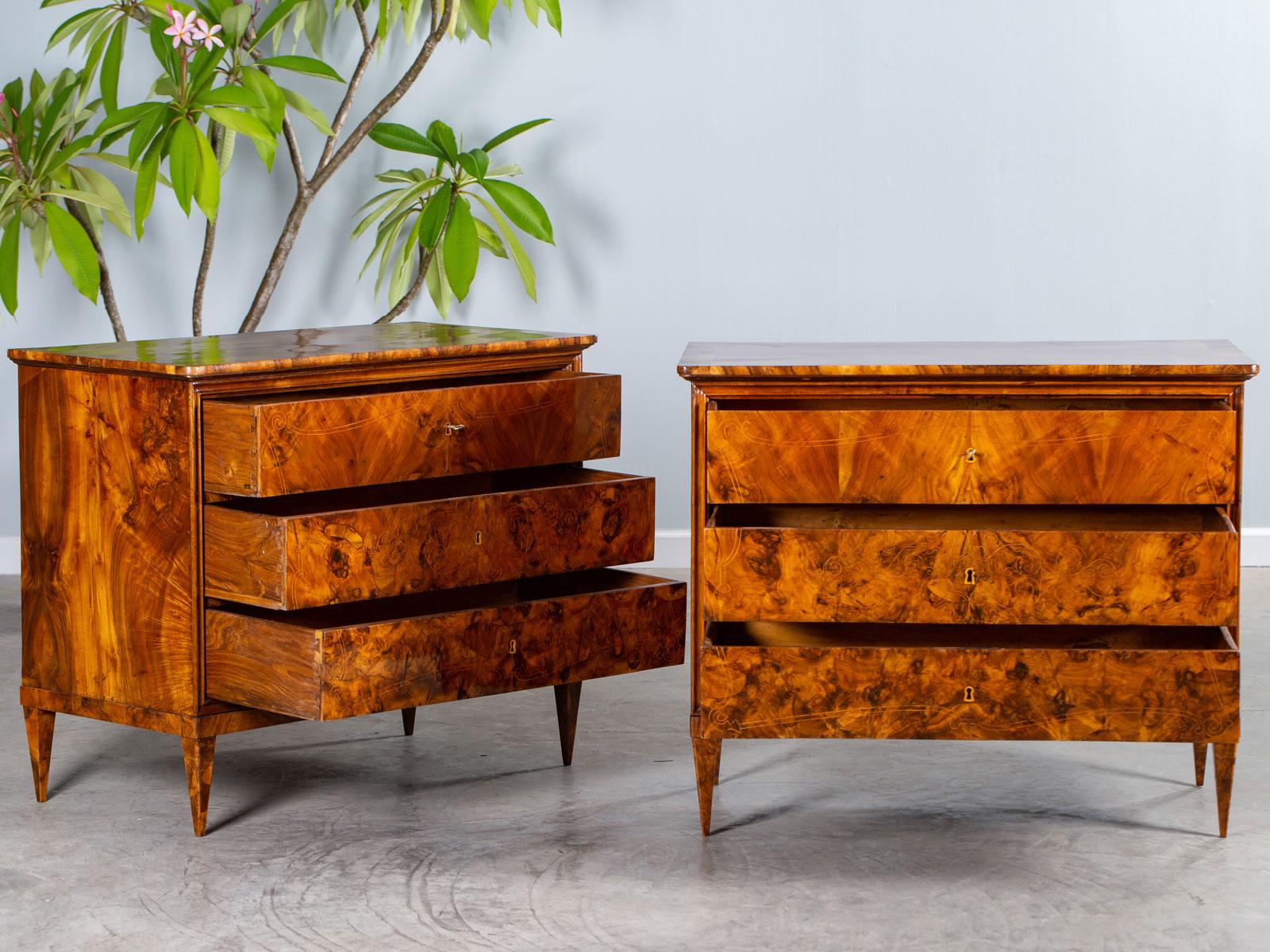 A pair of exceptional antique burl walnut with maple inlay chests of drawers, circa 1830s, possibly Spanish or French. The neoclassical styling of this pair of antique chests provides a marvelous framework for the organic pattern achieved by the use