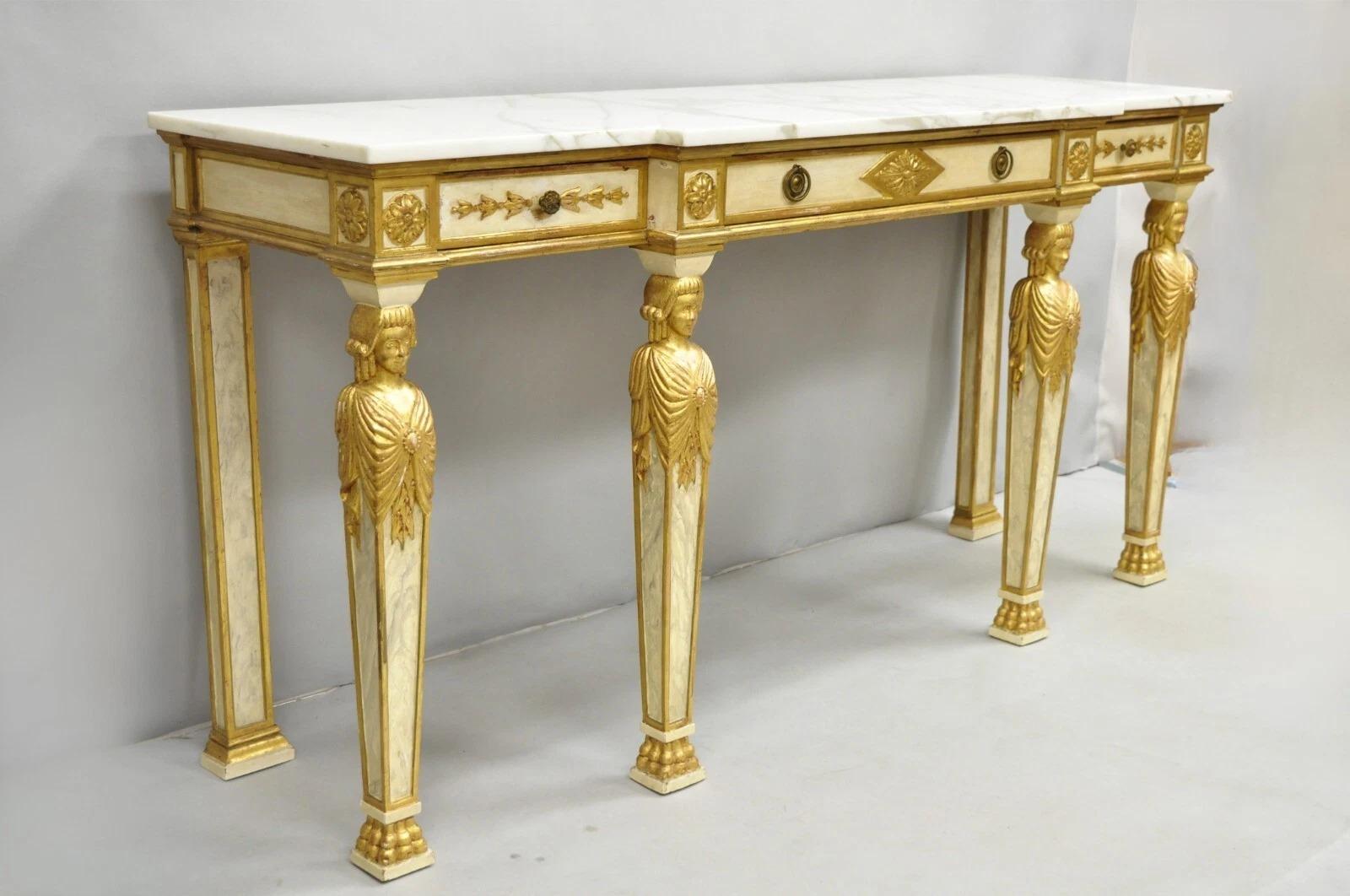 Antique Italian Neoclassical Cream & Gold Marble Top Figural Long Console Table. Item features 3 dovetailed drawers, white marble top, gold gilt trim, and legs with paw feet and women bust figures. Circa Early 20th Century. Measurements: 34.5