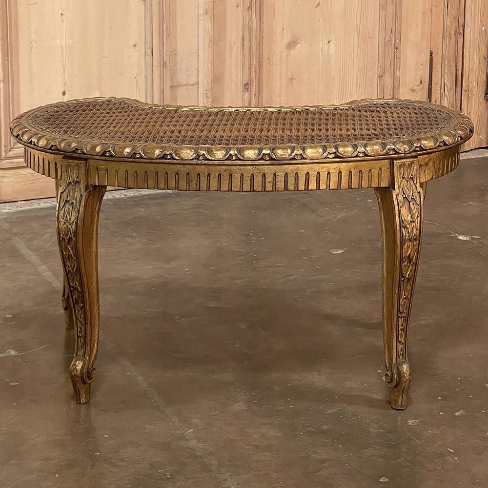 Antique Italian neoclassical giltwood & caned vanity bench was designed to provide lightweight comfort and timeless classical style! The kidney-shaped design can be flipped for different contours of vanities or counters, with a convex side opposing