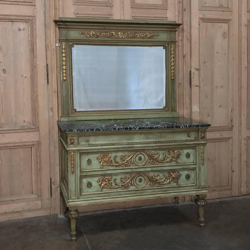 Antique Italian neoclassical painted mirror has been beautifully carved with exceptional foliate motifs across the facade, highlighted in patinaed gold which complements the painted finish wonderfully. Original bevelled mirror provides a lovely