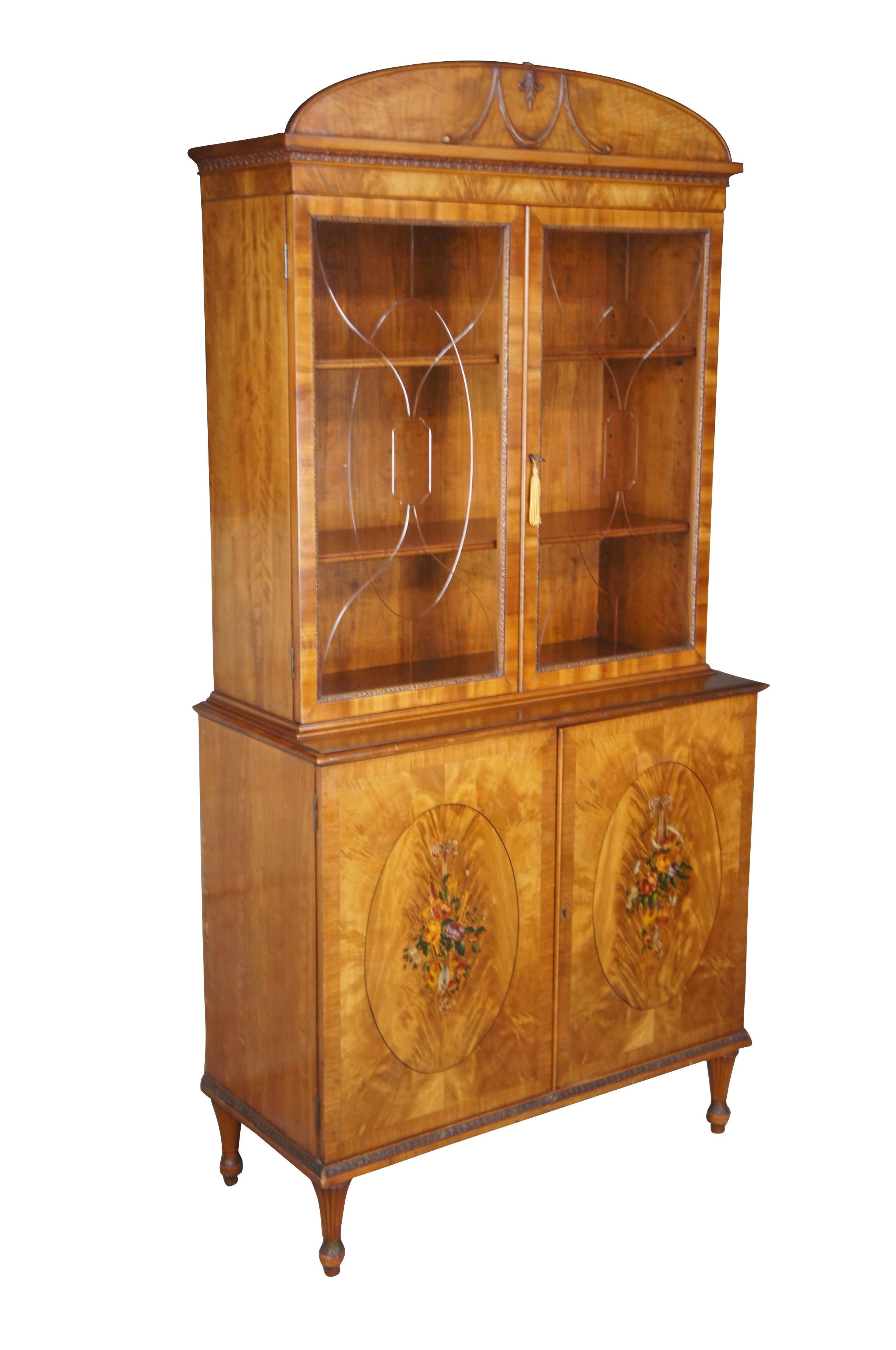Antique early 20th century Italian Neoclassical china cabinet or cupboard.  Made of satinwood featuring George III style beveled glass and hand painted doors with florals, ribbons, harp, trumpet / instruments, flag, banjo, cane, sheath of wheat,