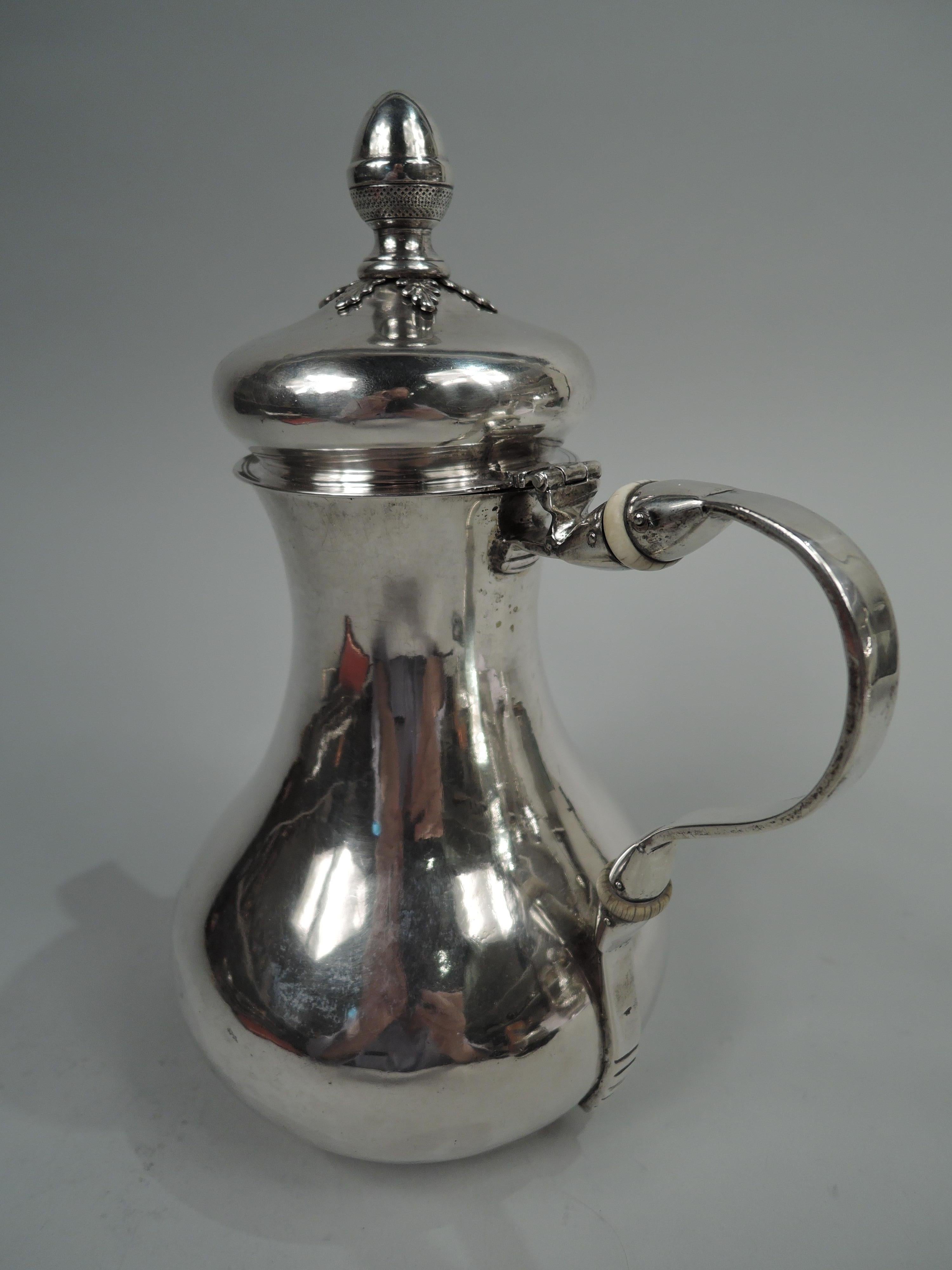 Italian Neoclassical silver coffeepot, ca 1820. Baluster; cover hinged and domed with leaf-mounted acorn finial. Applied c-scroll spout and scroll handle with ribbed tail. Handwork visible on interior. Marked. Weight: 25.4 troy ounces.  