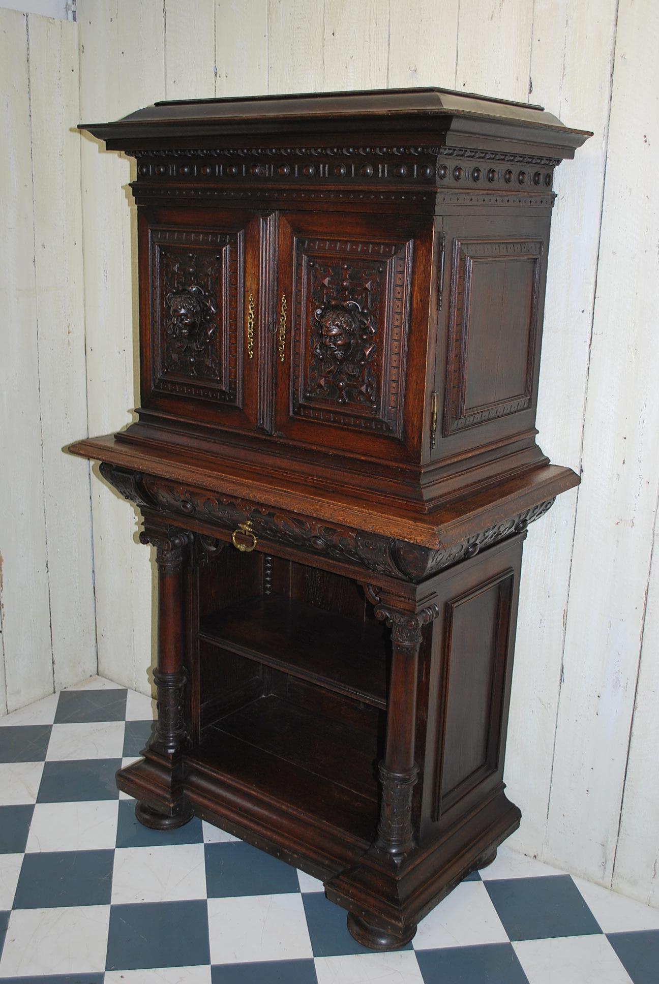 A very good quality Italian Renaissance Revival collectors cabinet on stand ,made in solid carved oak. The top section lifts off the base and has an adjustable shelf , the bottom section also has an adjustable shelf and a drawer in the cushion mold.