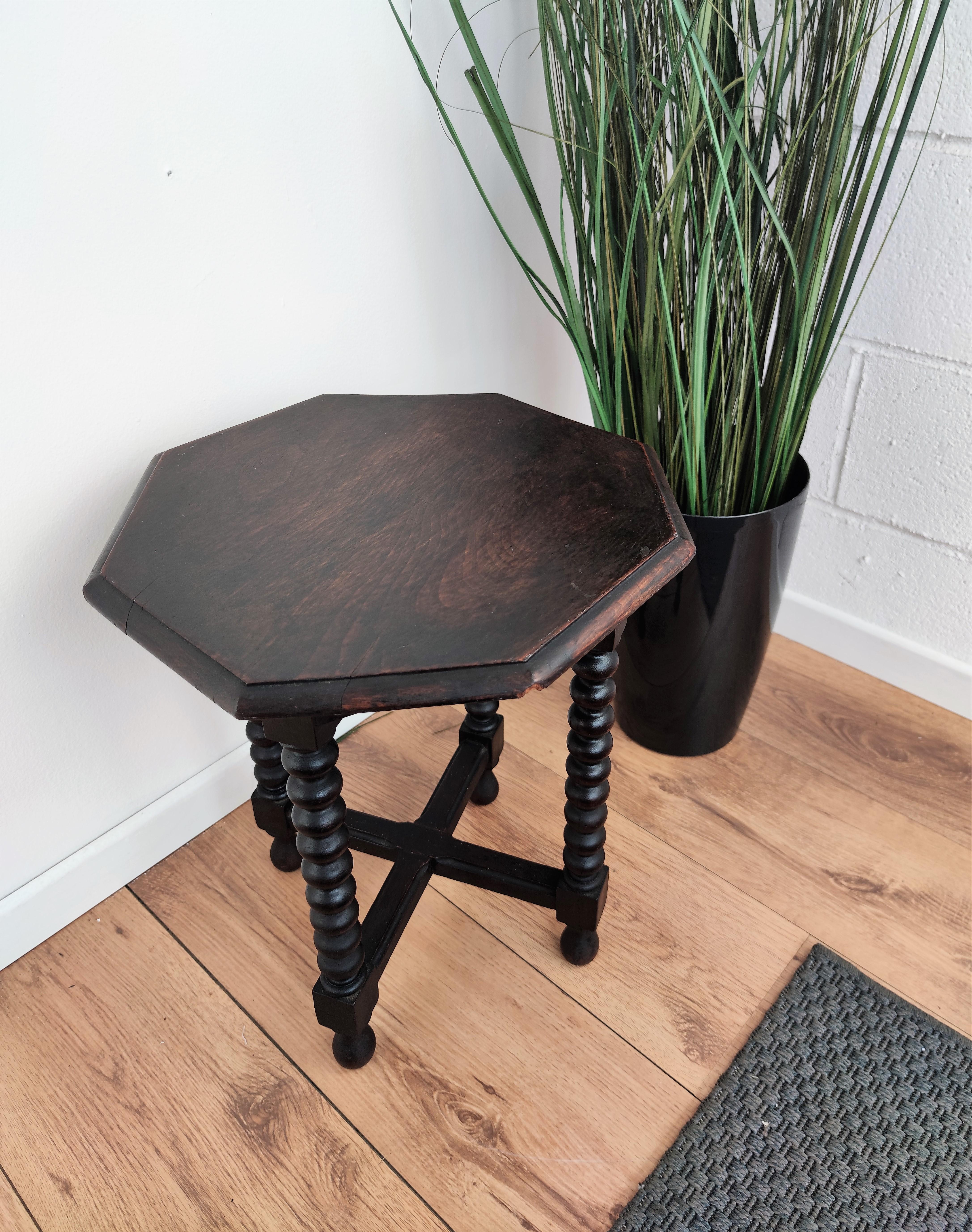 Beautiful antique Italian walnut side table or stool features octagonal top with beveled edges over four beautifully bobbin turned legs, connected to one another with cross-shaped central stretcher. This Italian walnut stool or side table with the
