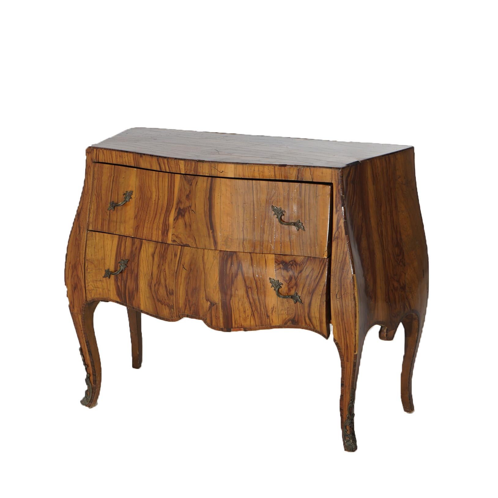 An antique Italian commode offers olive wood construction in bombe form with two drawers over shaped skirt, raised on cabriole legs; foliate cast ormolu mounts; c1930

Measures - 29
