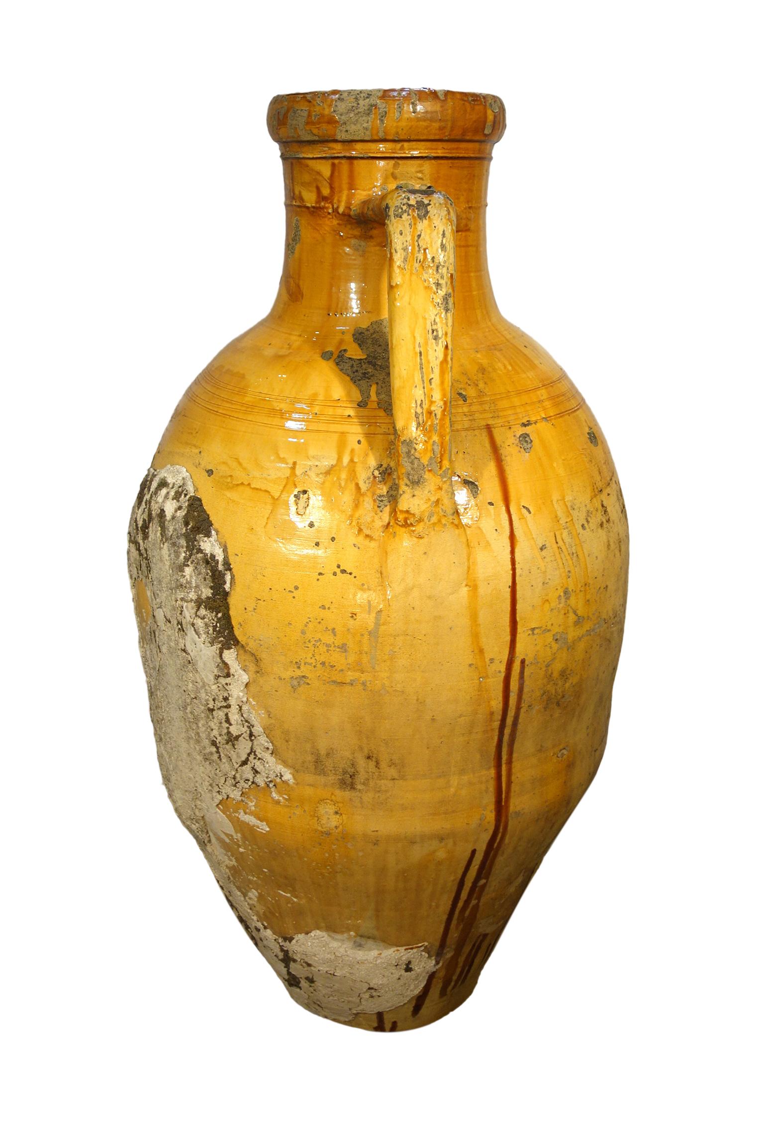 Antique Italian Orcio Puglia large terracotta vessel with bright golden ochre & umber glaze. Authentic Mediterranean antique pottery, two-handled amphora jar with lower spout from Apulia region of southern Italy. Handcrafted earthenware of