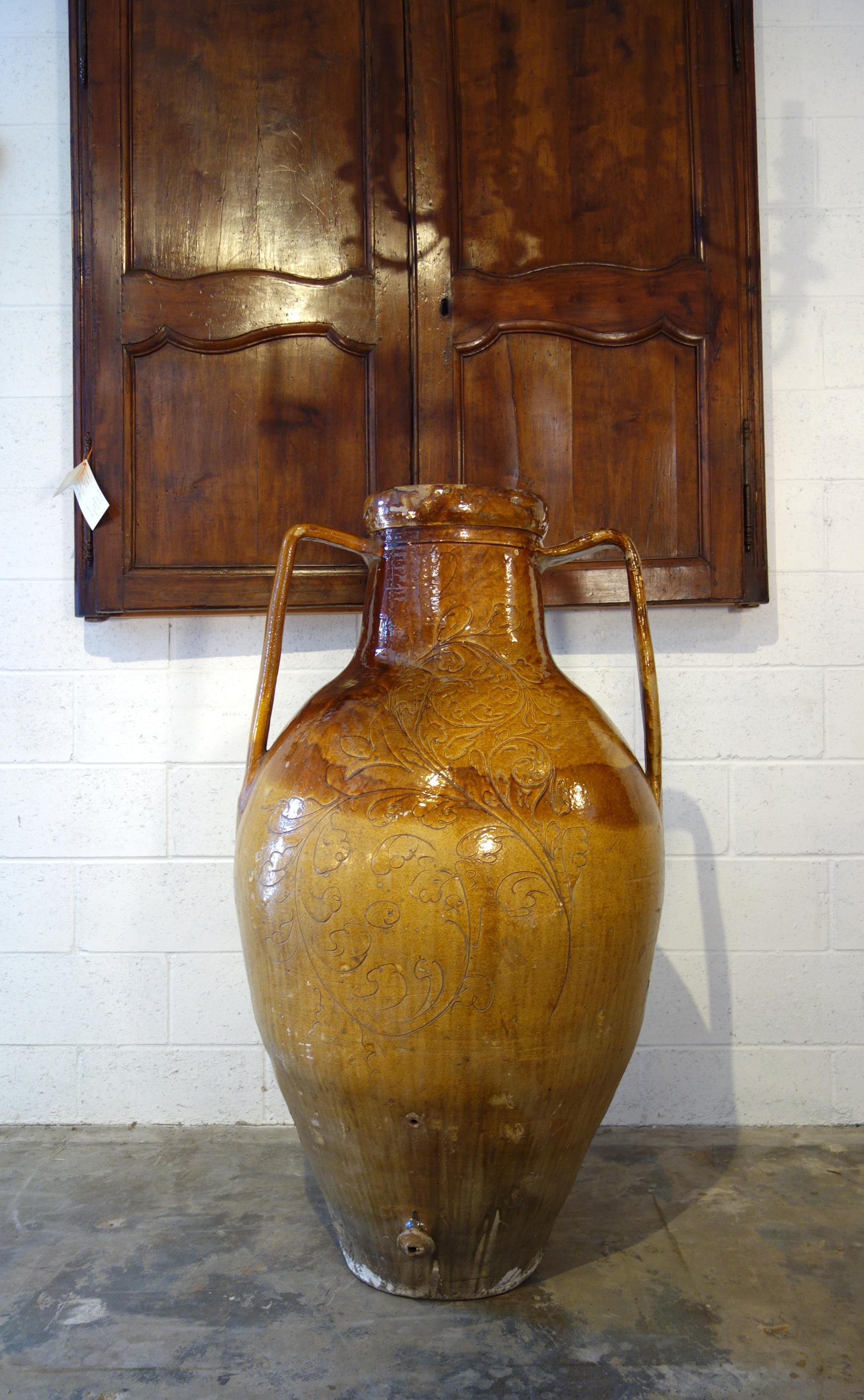 Mediterranean antique pottery, two-handled orcio jar with lower spout from Apulia region of southern Italy. Handcrafted earthenware of terracotta with unique Majolica glaze. Once used for storage and shipping jars for wine and olive oil. Perfect as