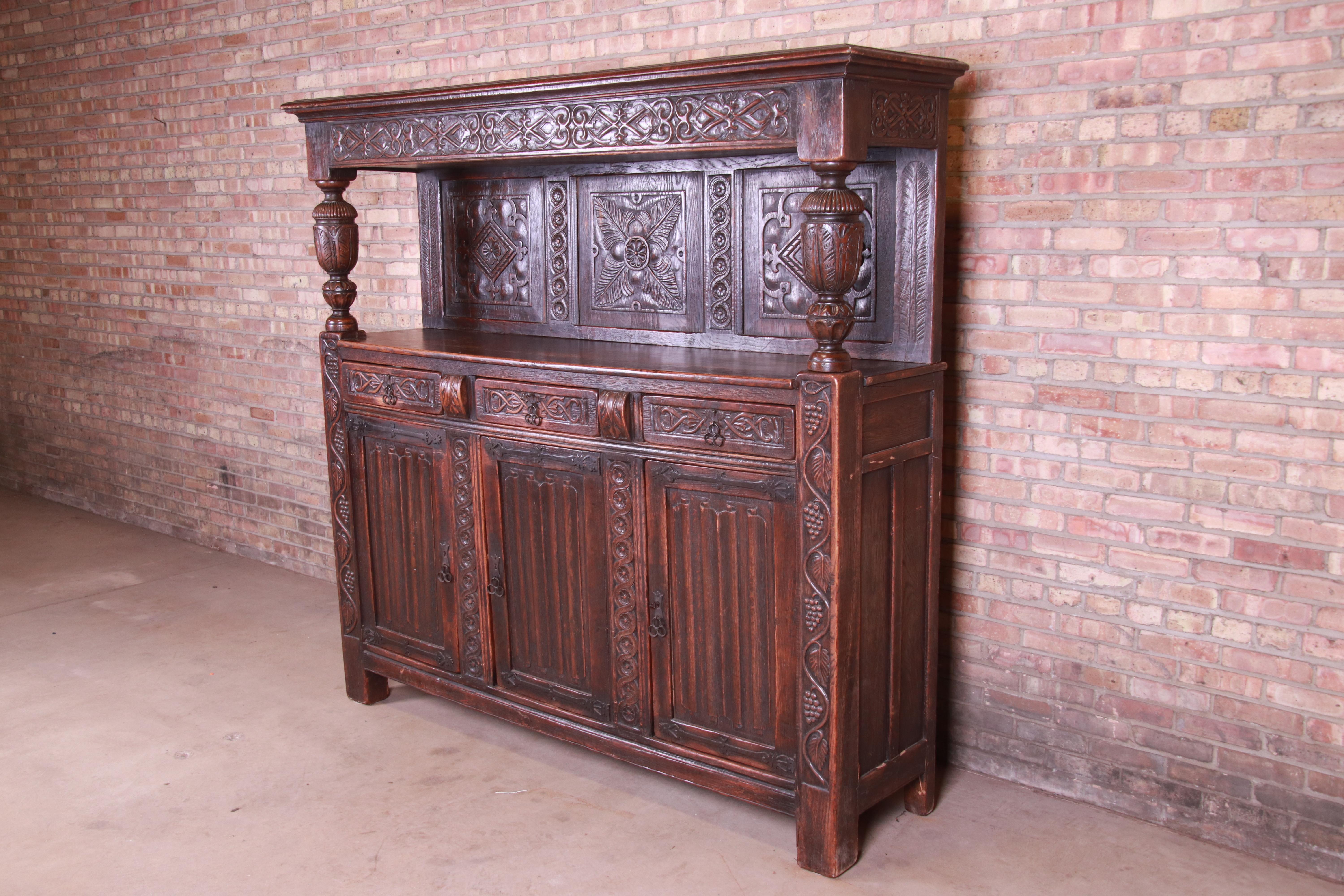 An exceptional antique Italian ornate carved oak sideboard or bar cabinet

Italy, circa 1800

Carved oak, with original wrought iron hardware

Measures: 78